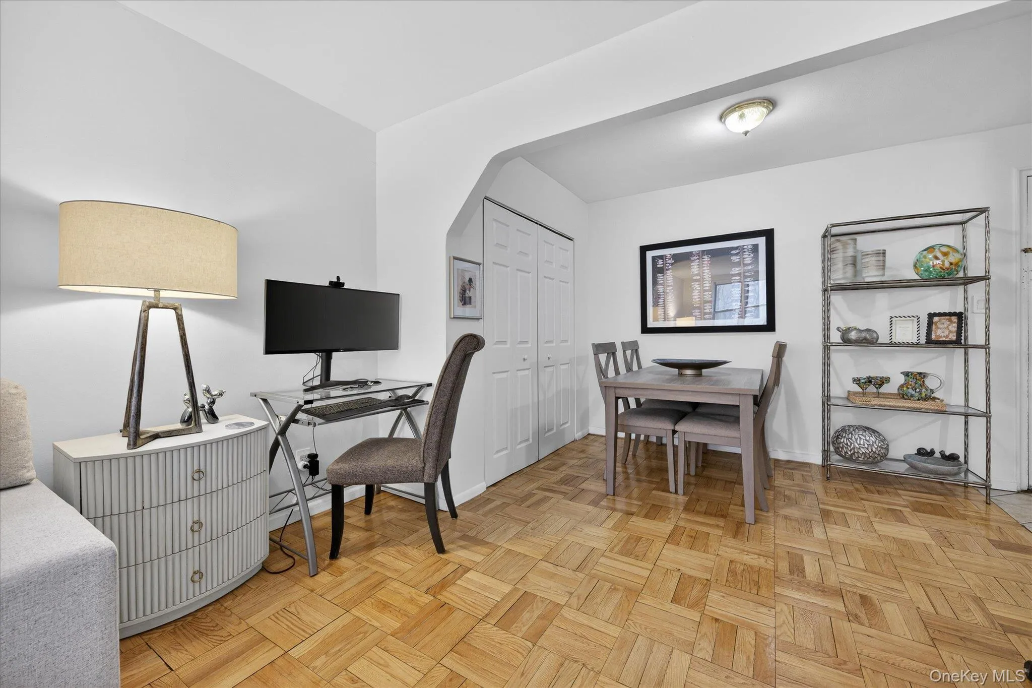 Office area featuring arched walkways and parquet floors Office area featuring arched walkways and parquet floors