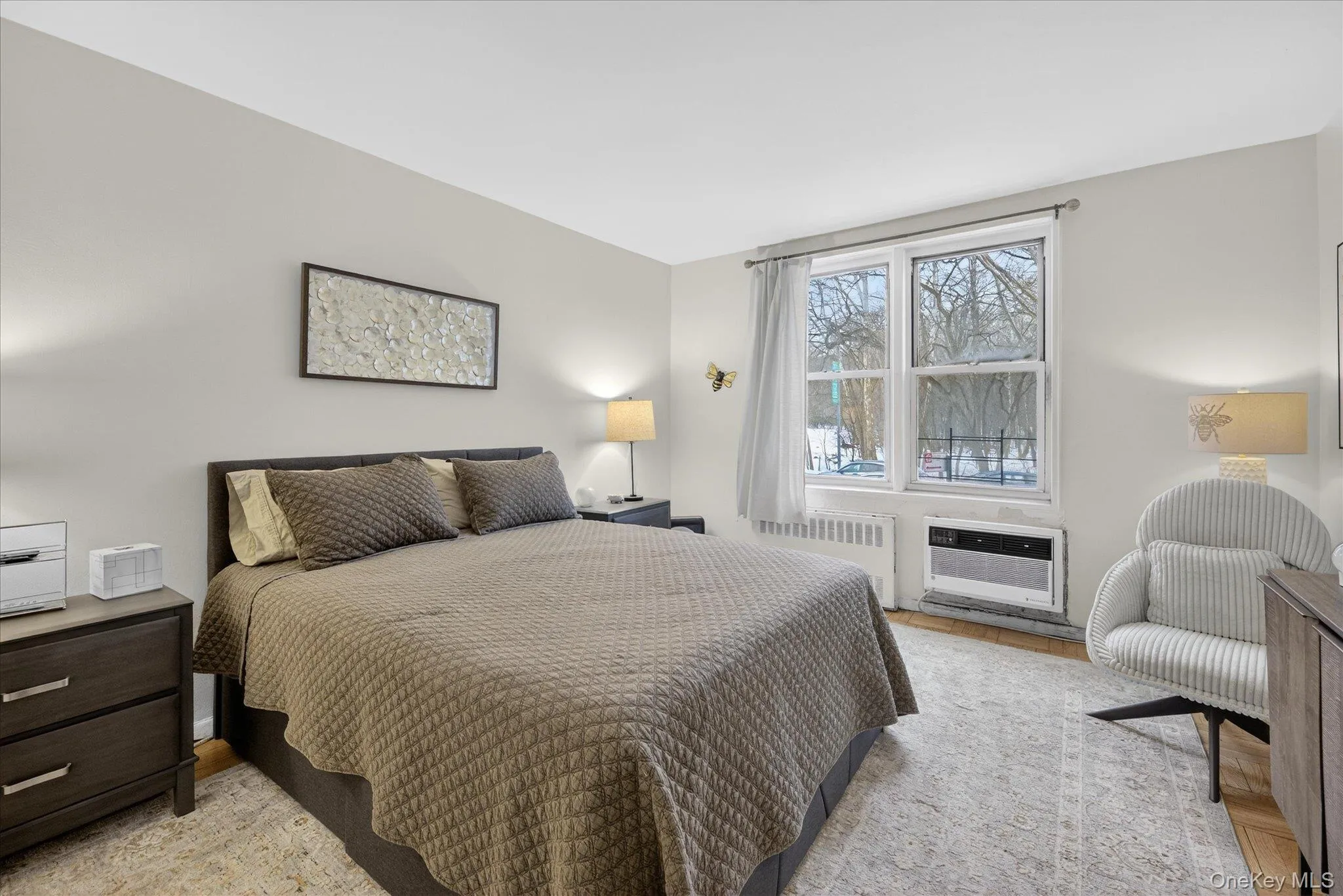 Bedroom with radiator and light wood finished floors Bedroom with radiator and light wood finished floors
