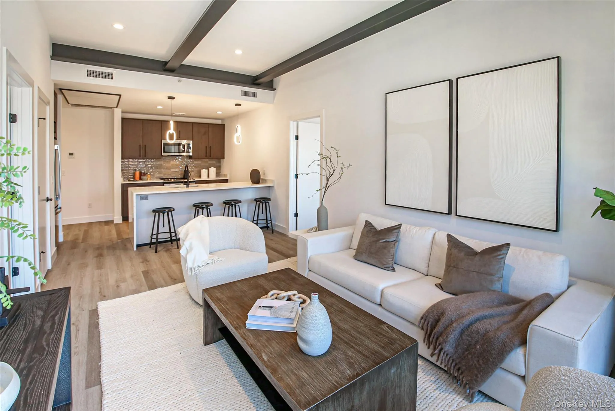 Living room with light wood-type flooring, beam ceiling, and recessed lighting Living room with light wood-type flooring, beam ceiling, and recessed lighting