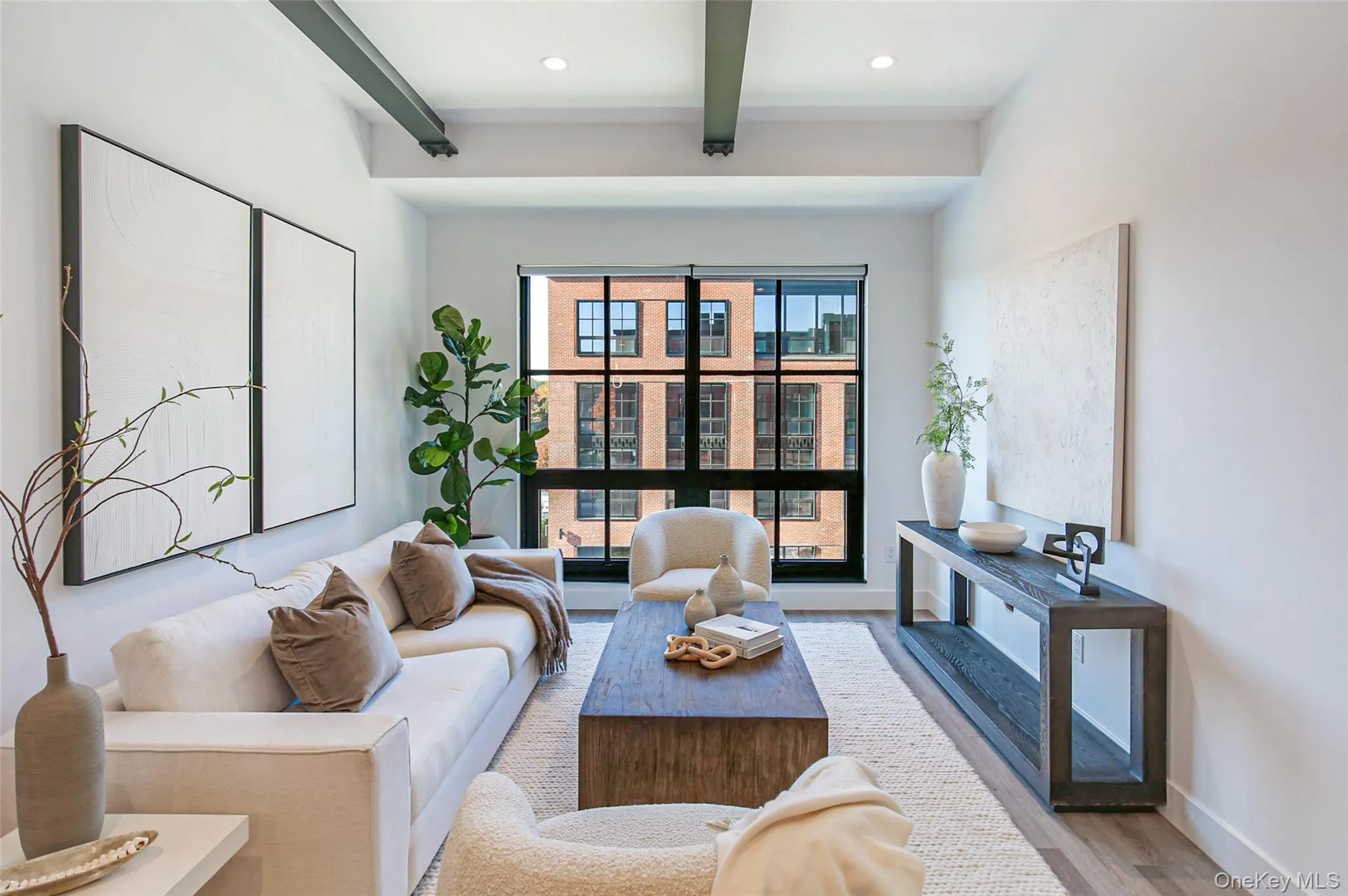 Living area with beam ceiling, light wood-type flooring, and recessed lighting Living area with beam ceiling, light wood-type flooring, and recessed lighting