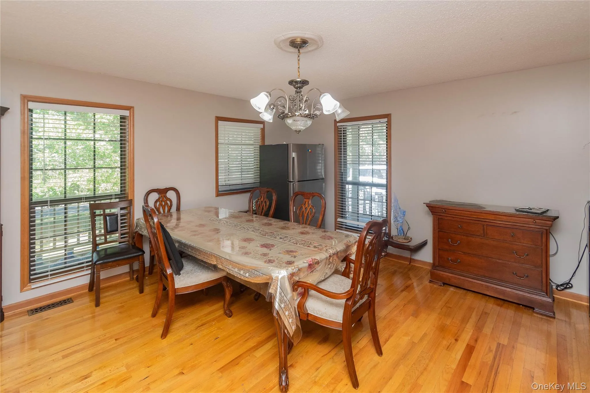 Dining room with hanging lights and light wood finished floors Dining room with hanging lights and light wood finished floors