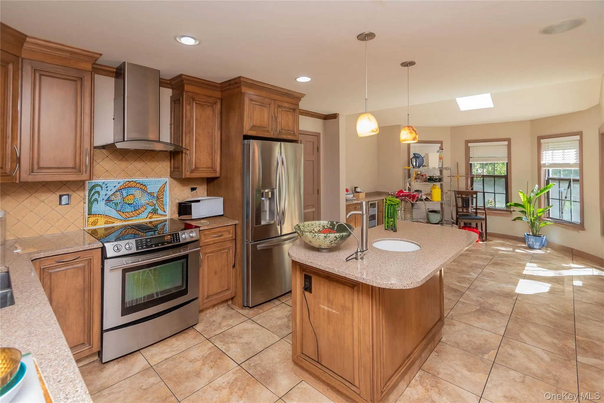 Kitchen with wood finish cabinetry, stainless steel appliances, light tile patterned flooring, and granite counters Kitchen with wood finish cabinetry, stainless steel appliances, light tile patterned flooring, and granite counters