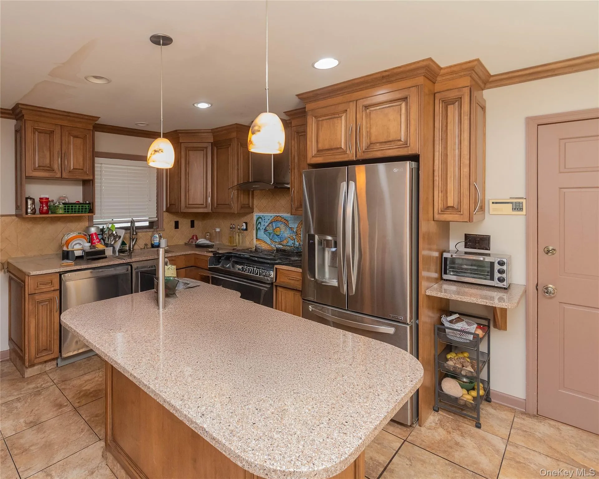 Kitchen with wood finish cabinetry, stainless steel appliances, light tile patterned flooring, and granite counters Kitchen with wood finish cabinetry, stainless steel appliances, light tile patterned flooring, and granite counters