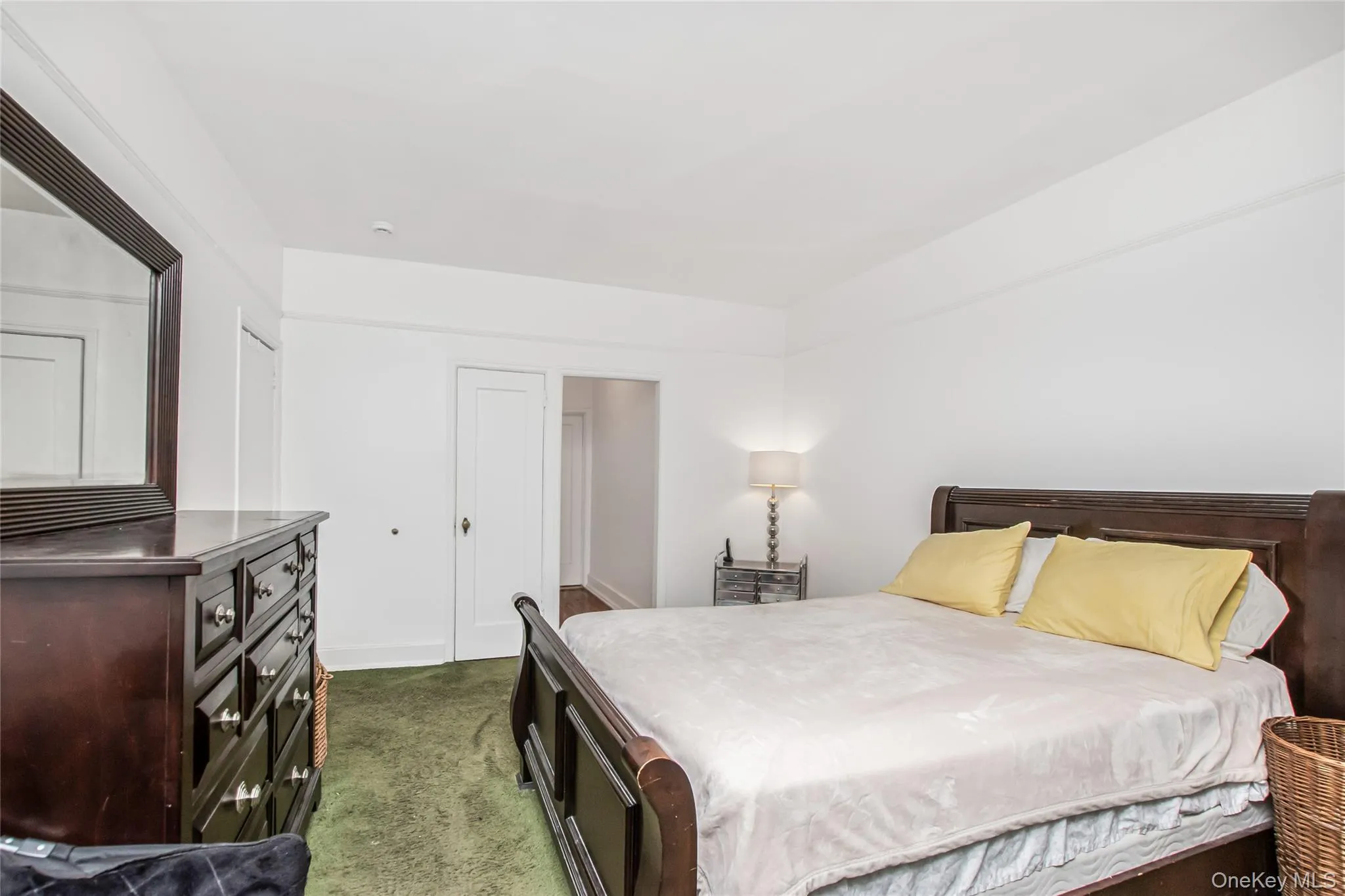 Bedroom featuring dark carpet and baseboards Bedroom featuring dark carpet and baseboards