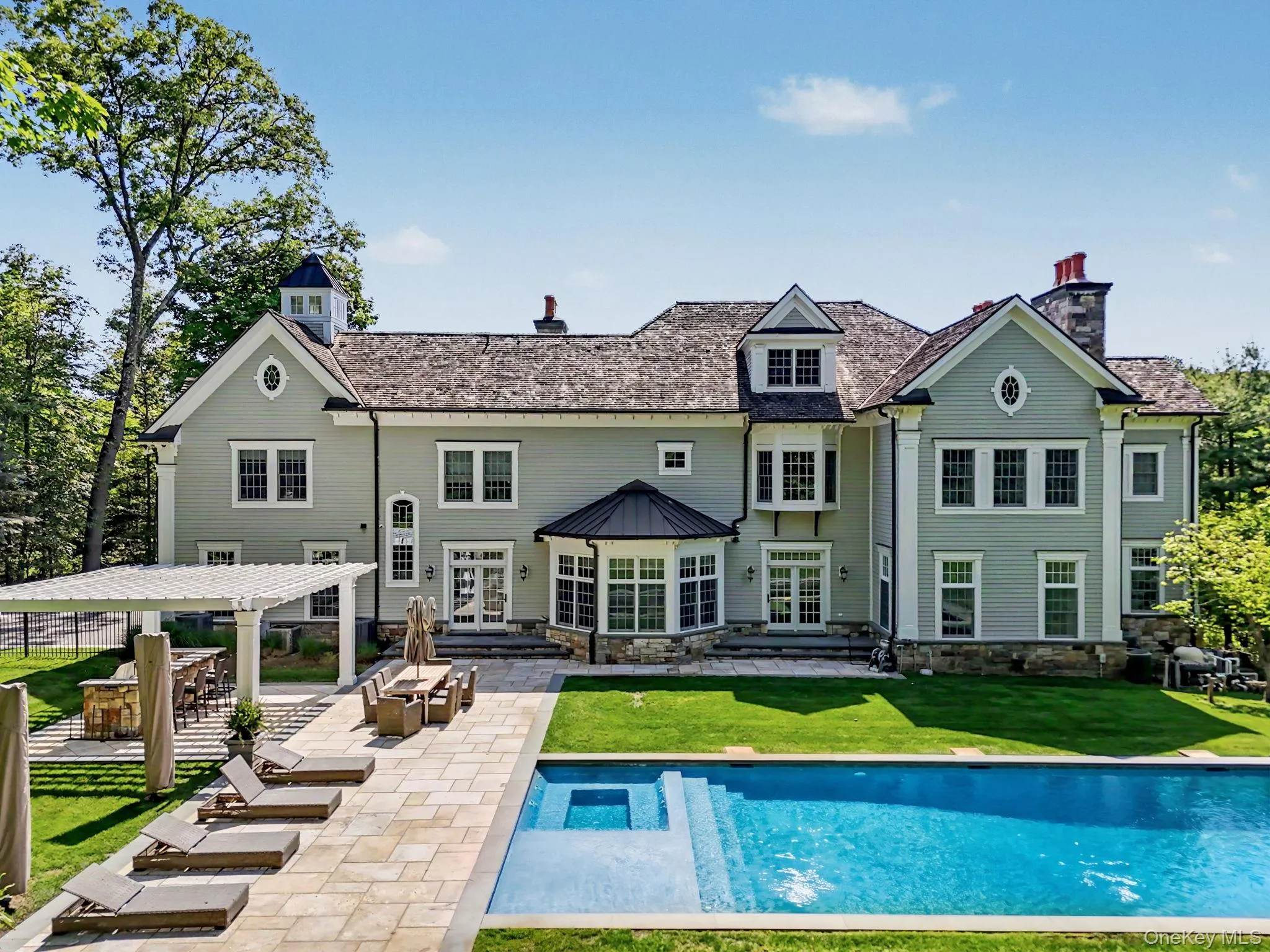 An oversized granite stone patio, custom-built outdoor kitchen, and spacious pergola complete this luxurious backyard retreat. An oversized granite stone patio, custom-built outdoor kitchen, and spacious pergola complete this luxurious backyard retreat.