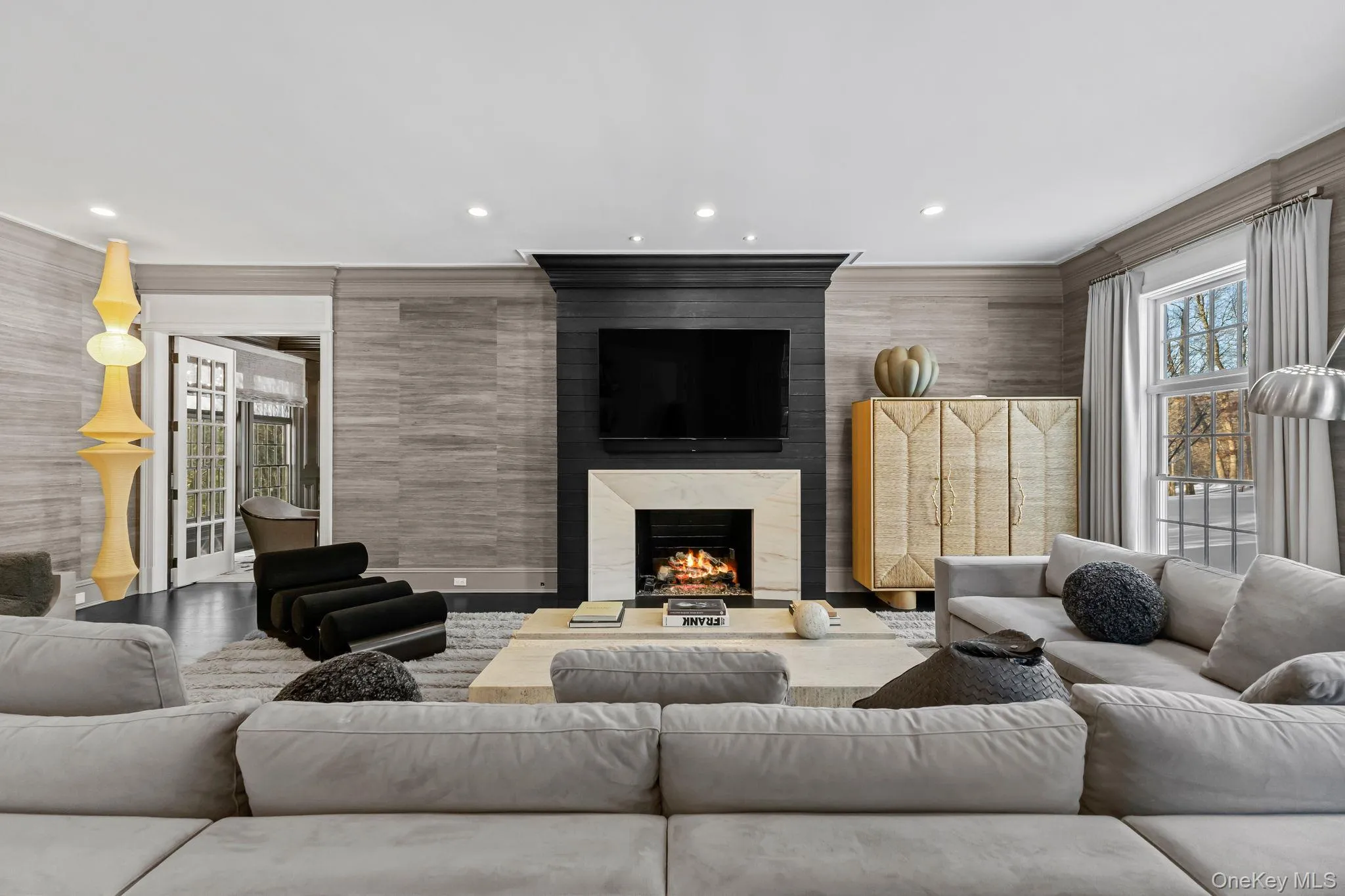 A generous Family Room anchored by a stunning fireplace, complemented by warm decor, custom lighting, and inviting seating, perfectly positioned at the heart of the home, where relaxation begins at the end of each day. A generous Family Room anchored by a stunning fireplace, complemented by warm decor, custom lighting, and inviting seating, perfectly positioned at the heart of the home, where relaxation begins at the end of each day.