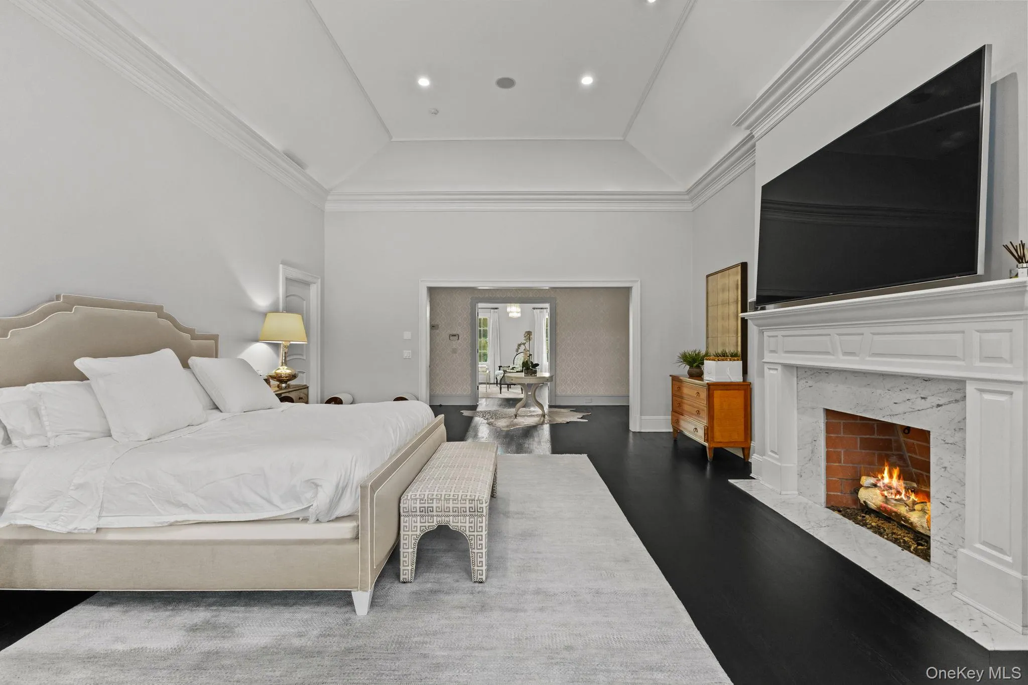 The enchanting owner’s bedroom adjoins a cozy sitting room, elegantly separated by French doors. The enchanting owner’s bedroom adjoins a cozy sitting room, elegantly separated by French doors.