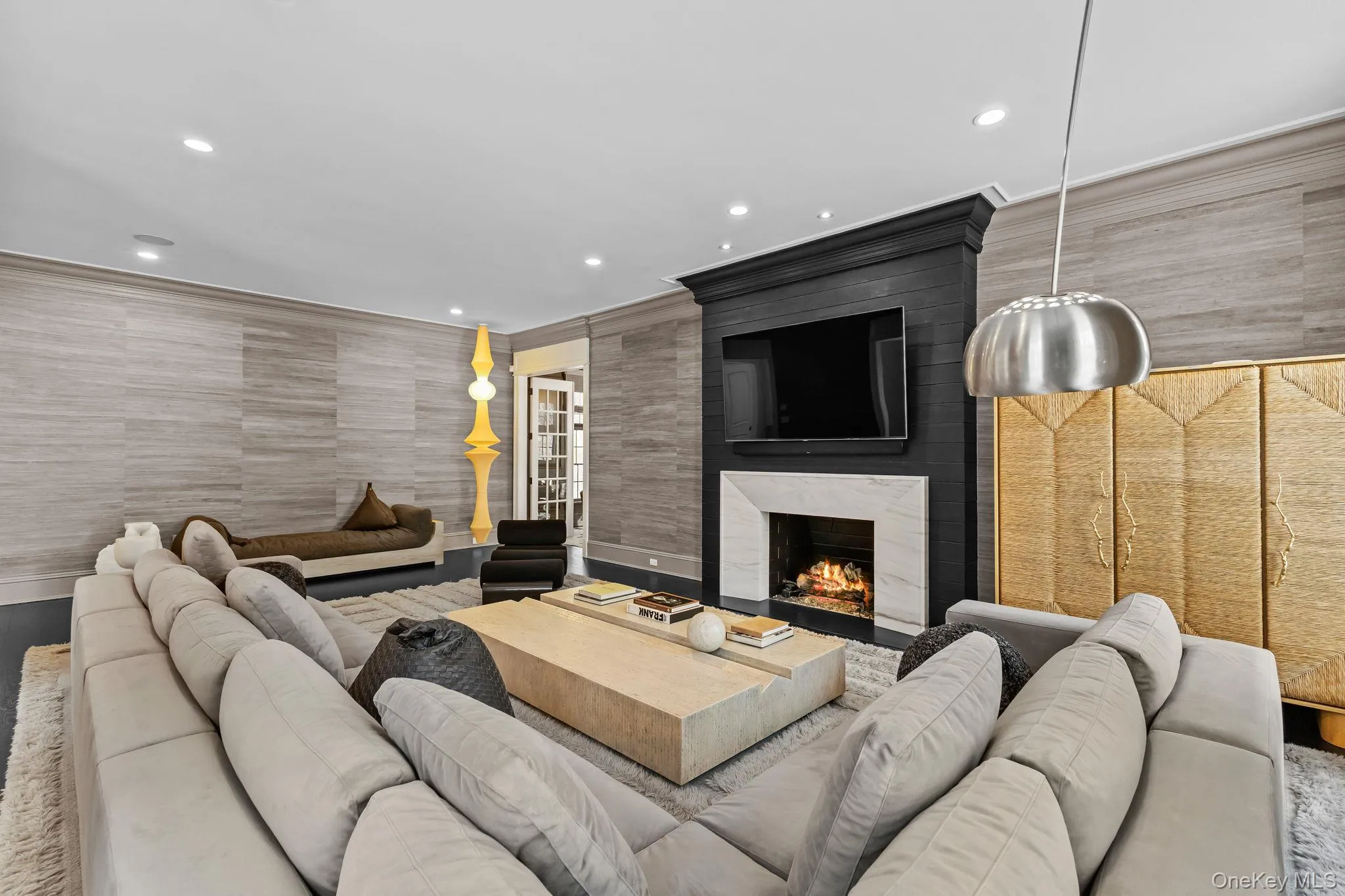 Open to the kitchen, this fabulous family room flows seamlessly through elegant French doors into a private home office, offering the perfect balance of connection and quiet retreat. Open to the kitchen, this fabulous family room flows seamlessly through elegant French doors into a private home office, offering the perfect balance of connection and quiet retreat.
