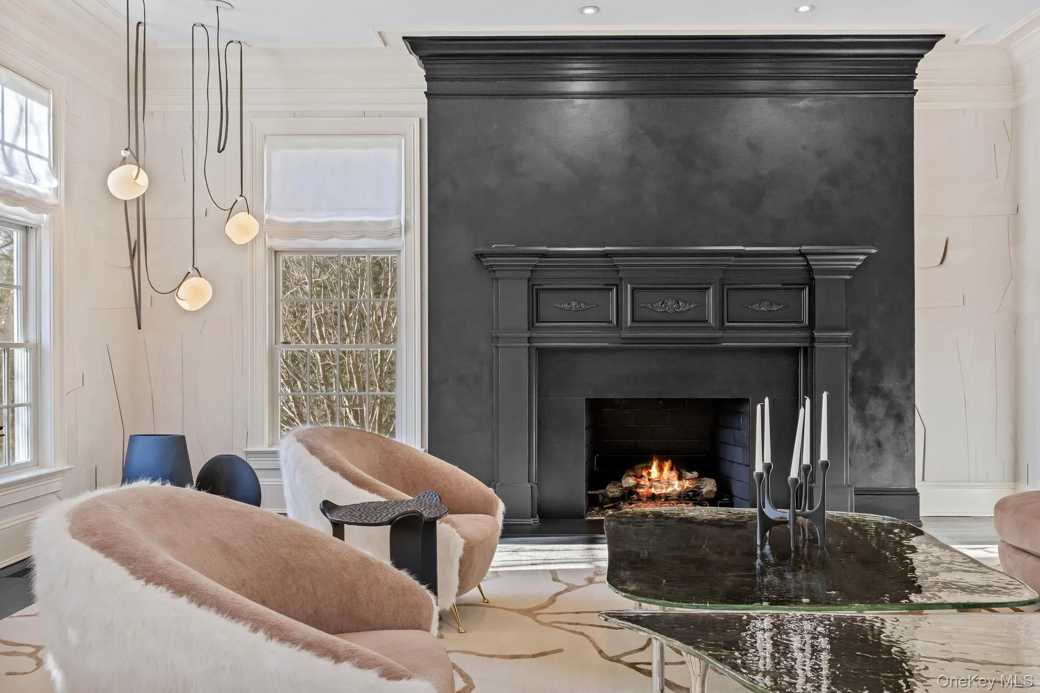 Centered around a beautiful fireplace featuring a custom wood mantel and elegant marble surround, the space exudes warmth and refined architectural detail. Centered around a beautiful fireplace featuring a custom wood mantel and elegant marble surround, the space exudes warmth and refined architectural detail.