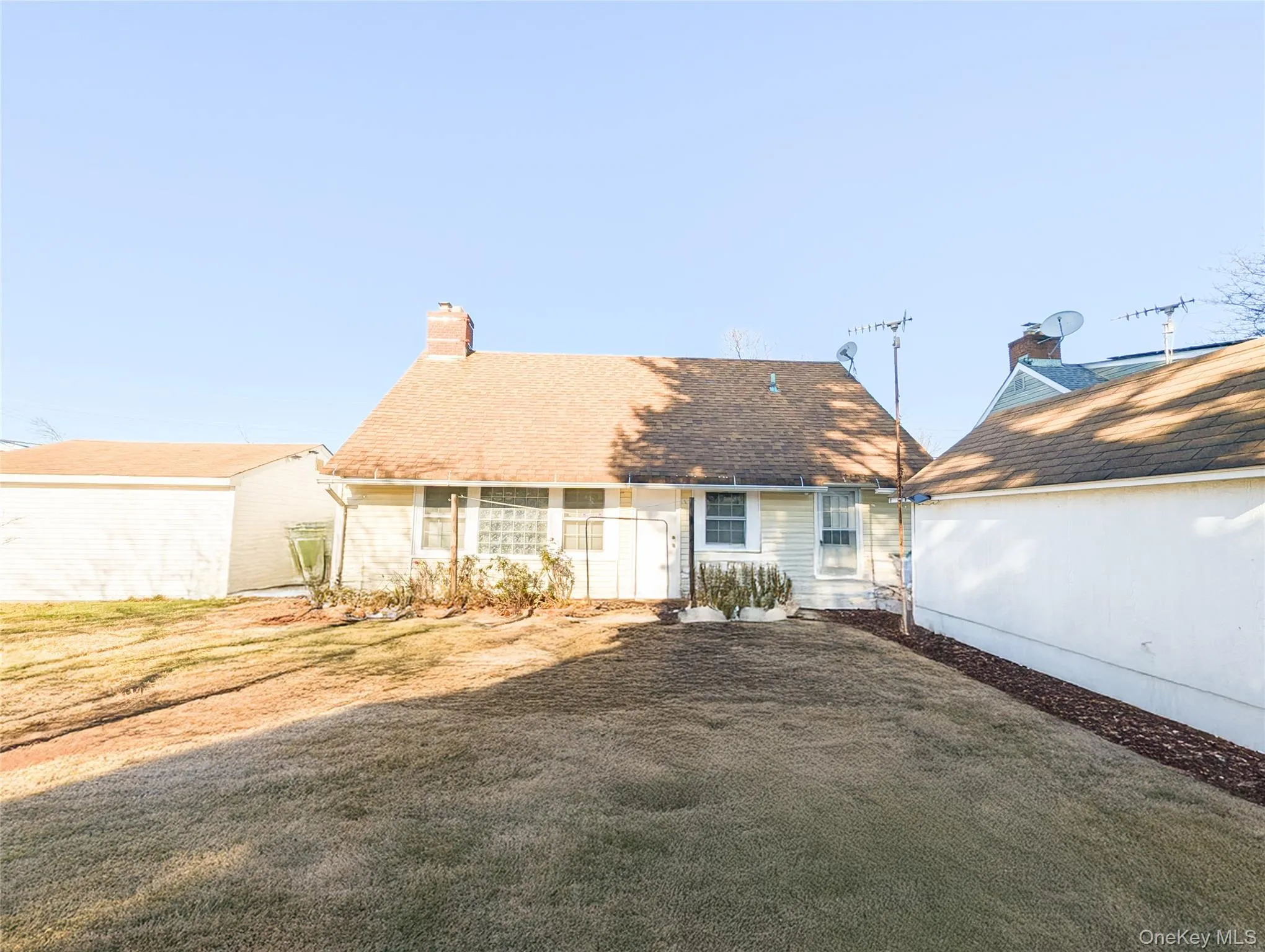 Back of house with a yard Back of house with a yard