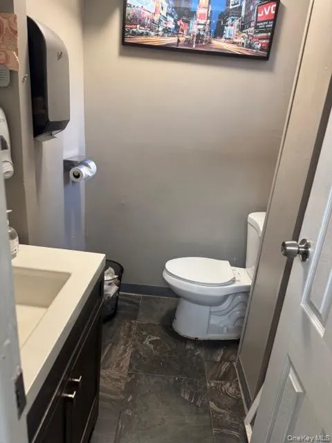 Half bath with toilet and vanity Half bath with toilet and vanity