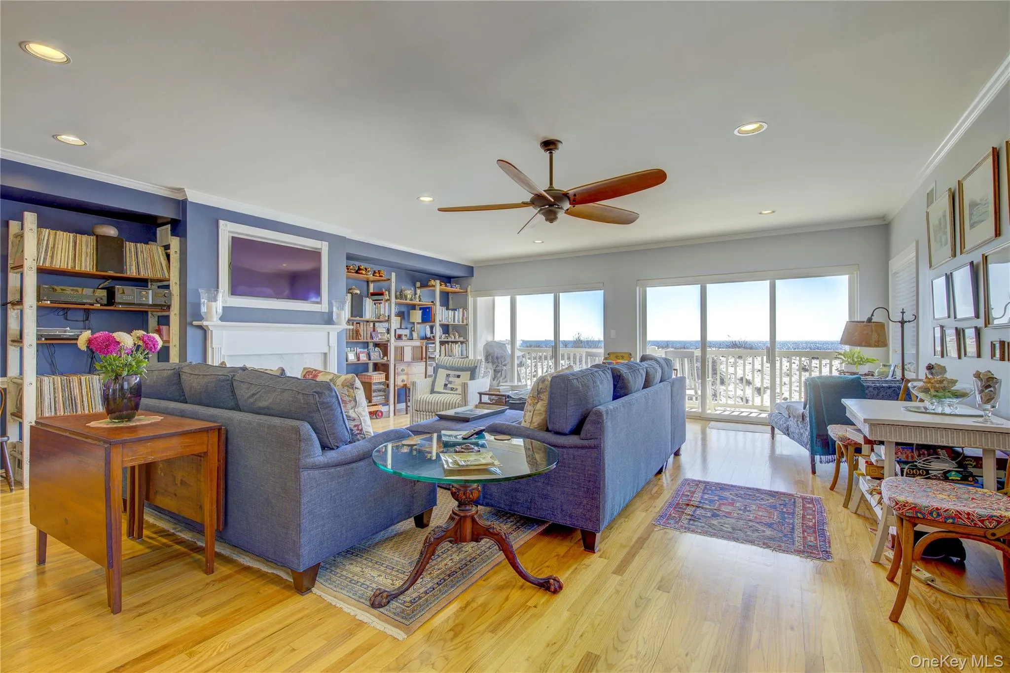 Living room with crown molding, light wood-style flooring, recessed lighting, and a ceiling fan Living room with crown molding, light wood-style flooring, recessed lighting, and a ceiling fan