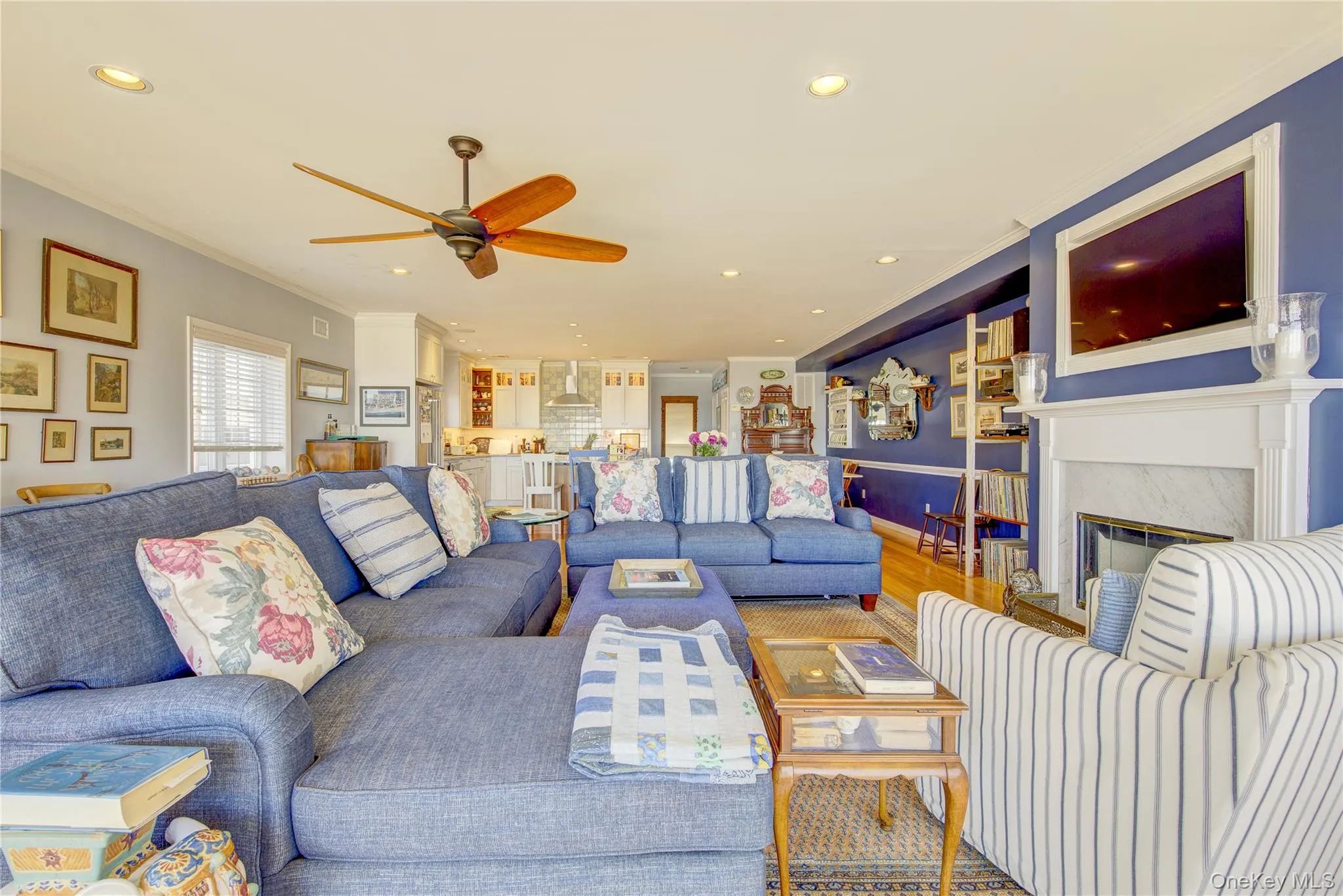 Living area with a fireplace, crown molding, recessed lighting, and a ceiling fan Living area with a fireplace, crown molding, recessed lighting, and a ceiling fan