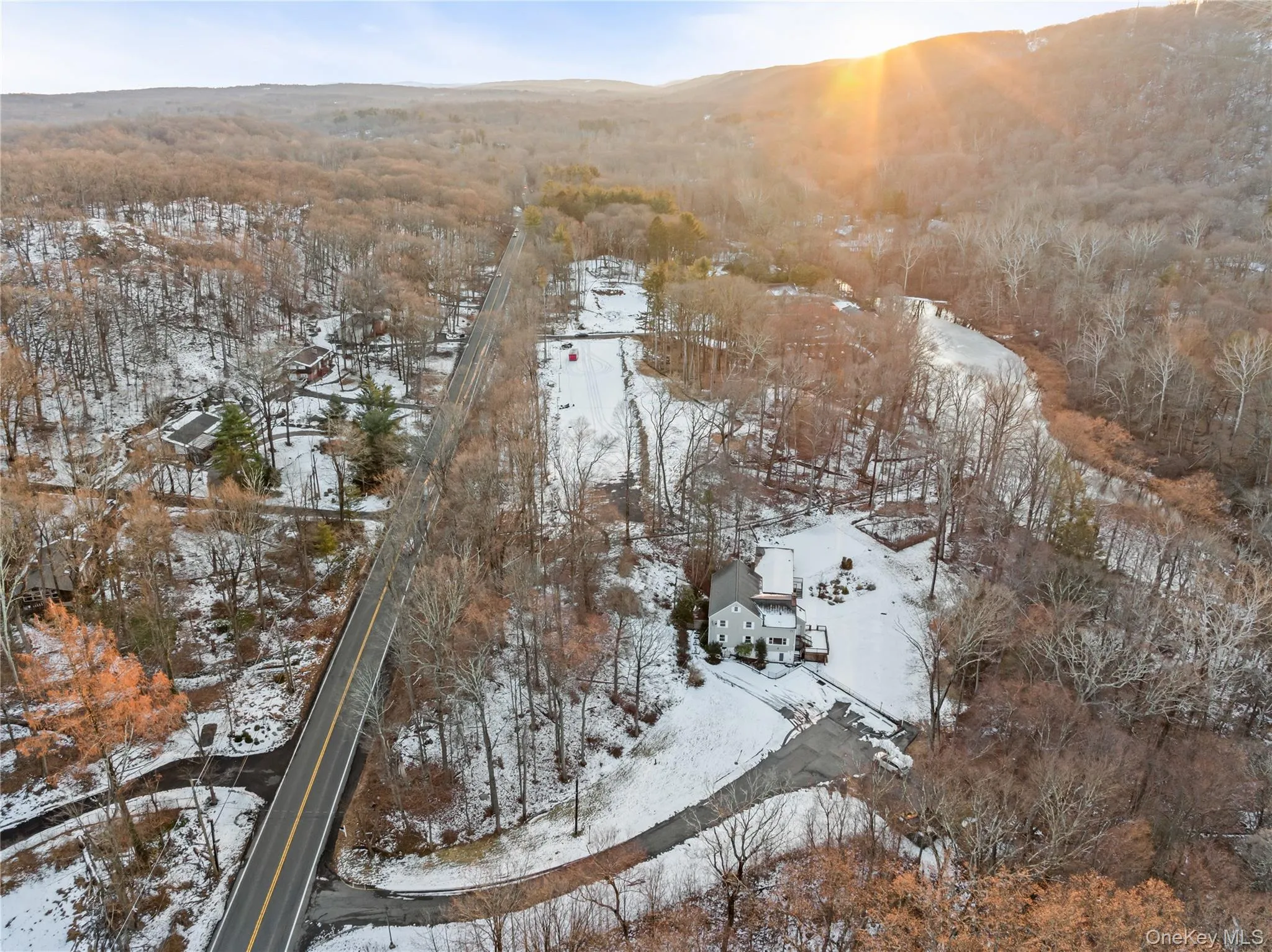 Snowy aerial view featuring a mountain view Snowy aerial view featuring a mountain view