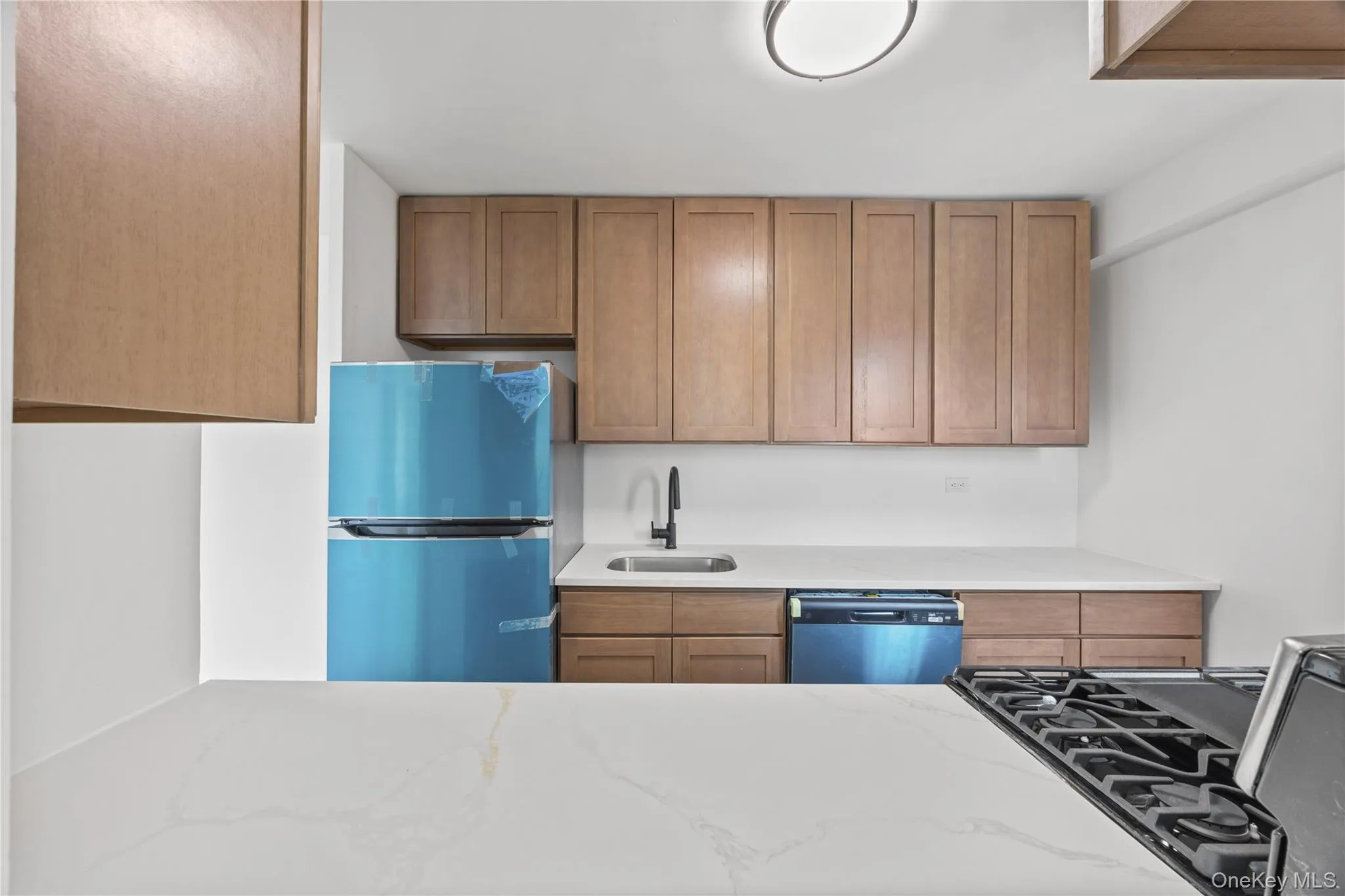 New cabinetry featuring neutral quartz counter tops New cabinetry featuring neutral quartz counter tops