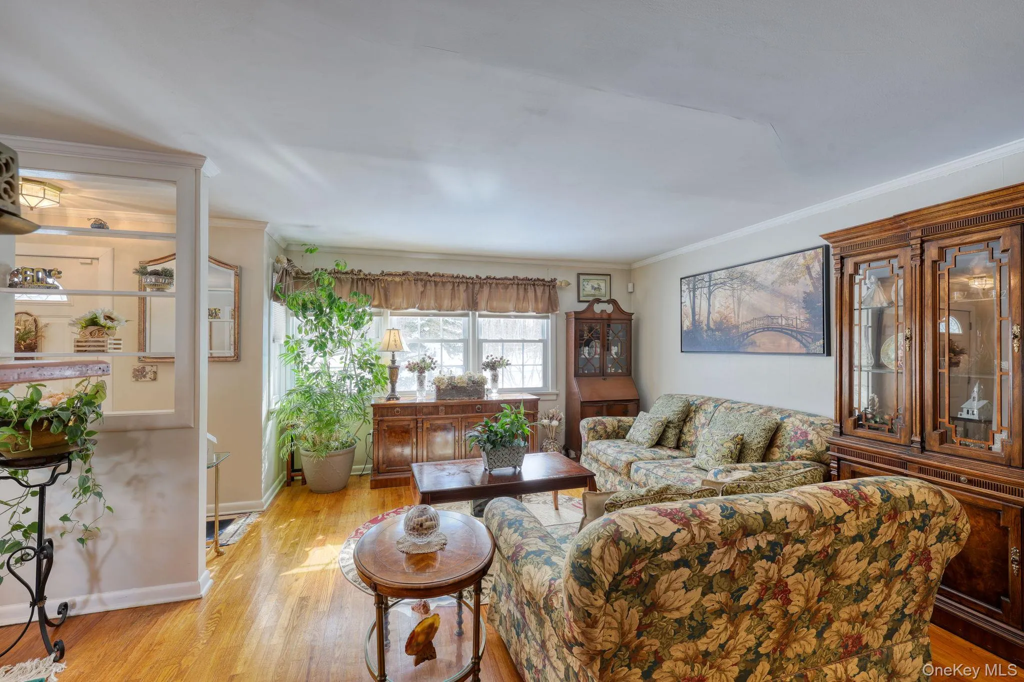 Light-filled livingroom with hardwood flooring. Light-filled livingroom with hardwood flooring.