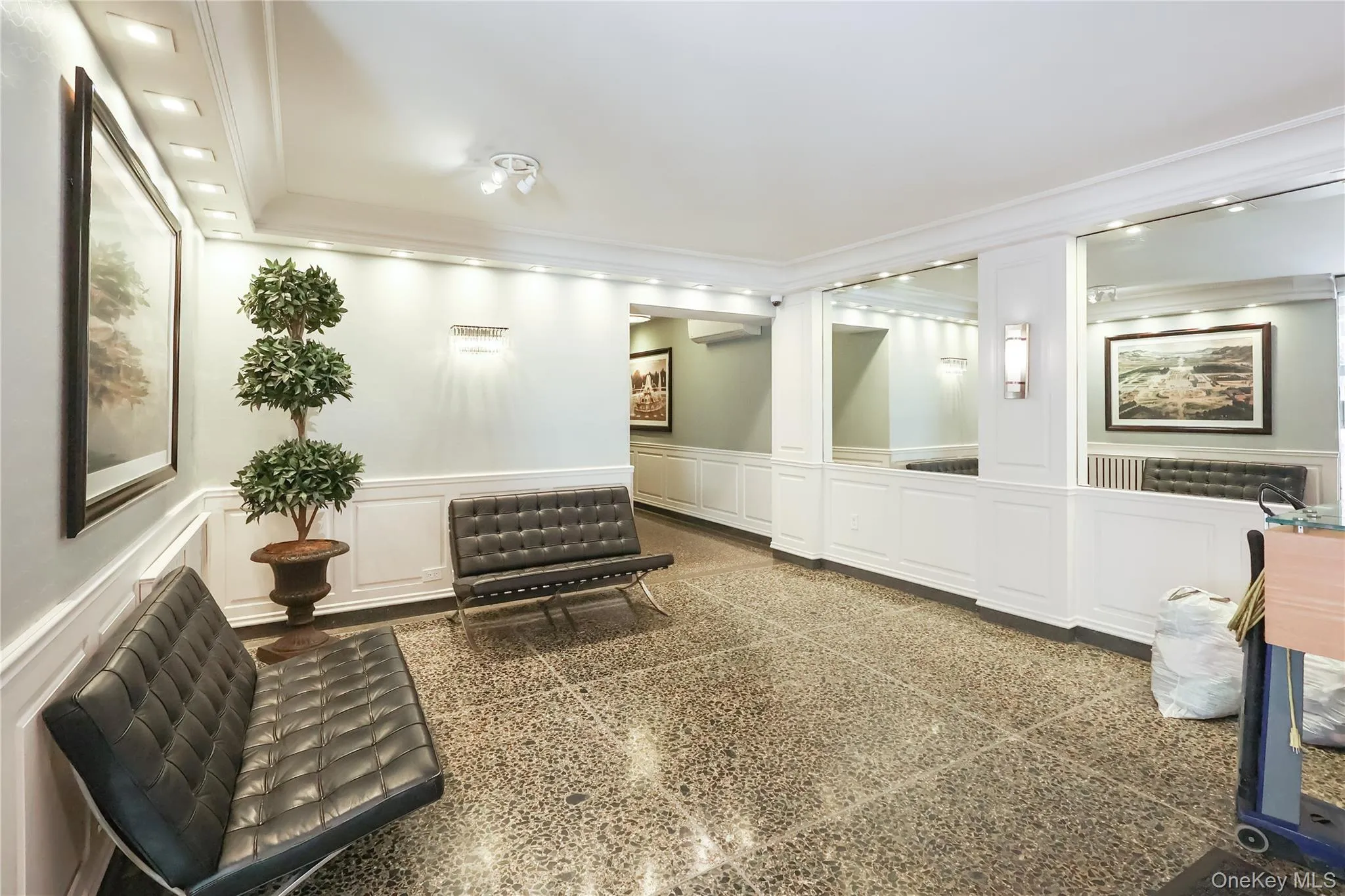 Common area with a decorative wall, wainscoting, ornamental molding, and recessed lighting Common area with a decorative wall, wainscoting, ornamental molding, and recessed lighting