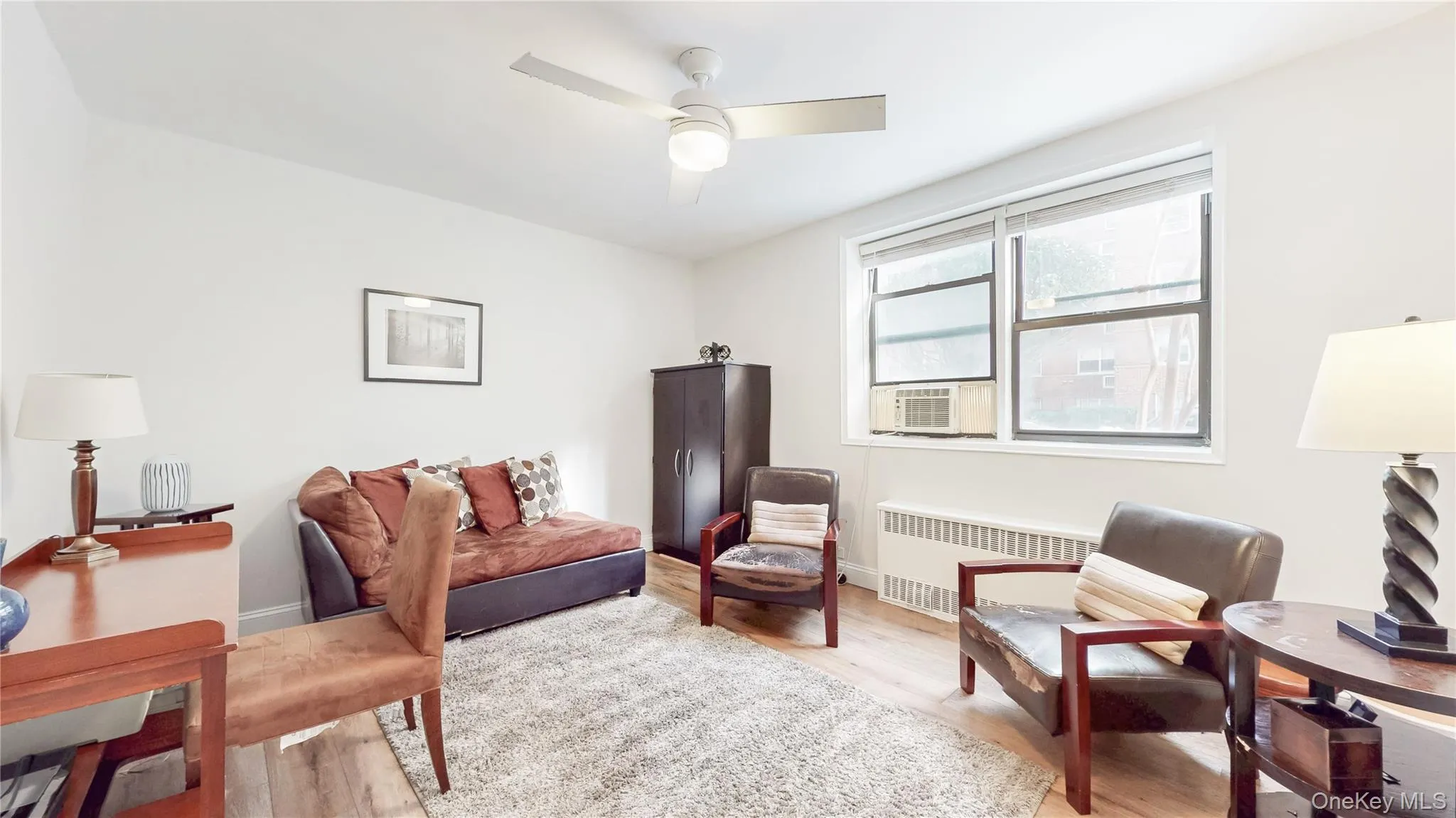 Second Office featuring radiator heating unit, light wood finished floors, and cooling unit Second Office featuring radiator heating unit, light wood finished floors, and cooling unit