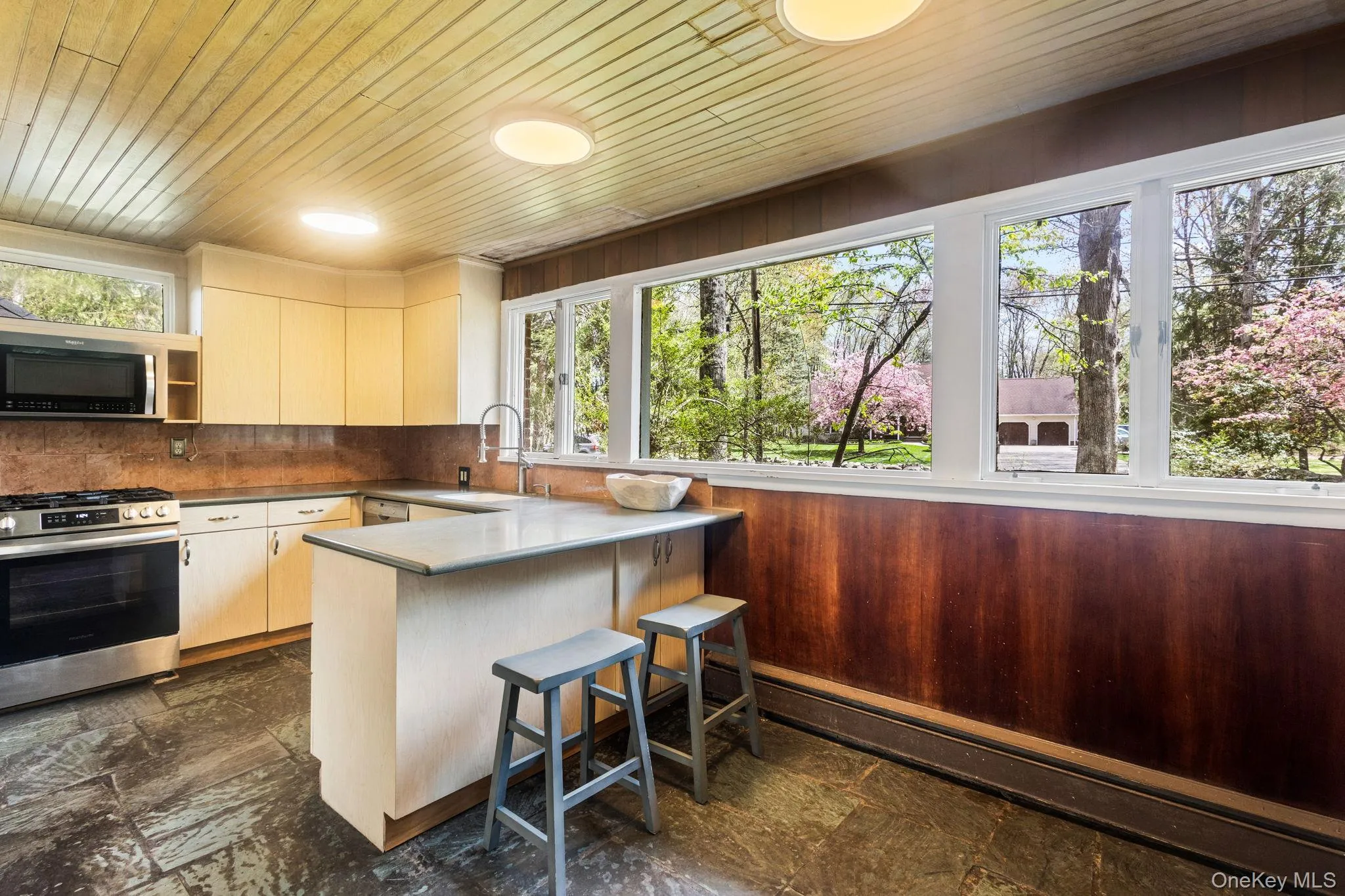 Wall of Windows brings in Garden Views and Soft Natural Light. Wall of Windows brings in Garden Views and Soft Natural Light.
