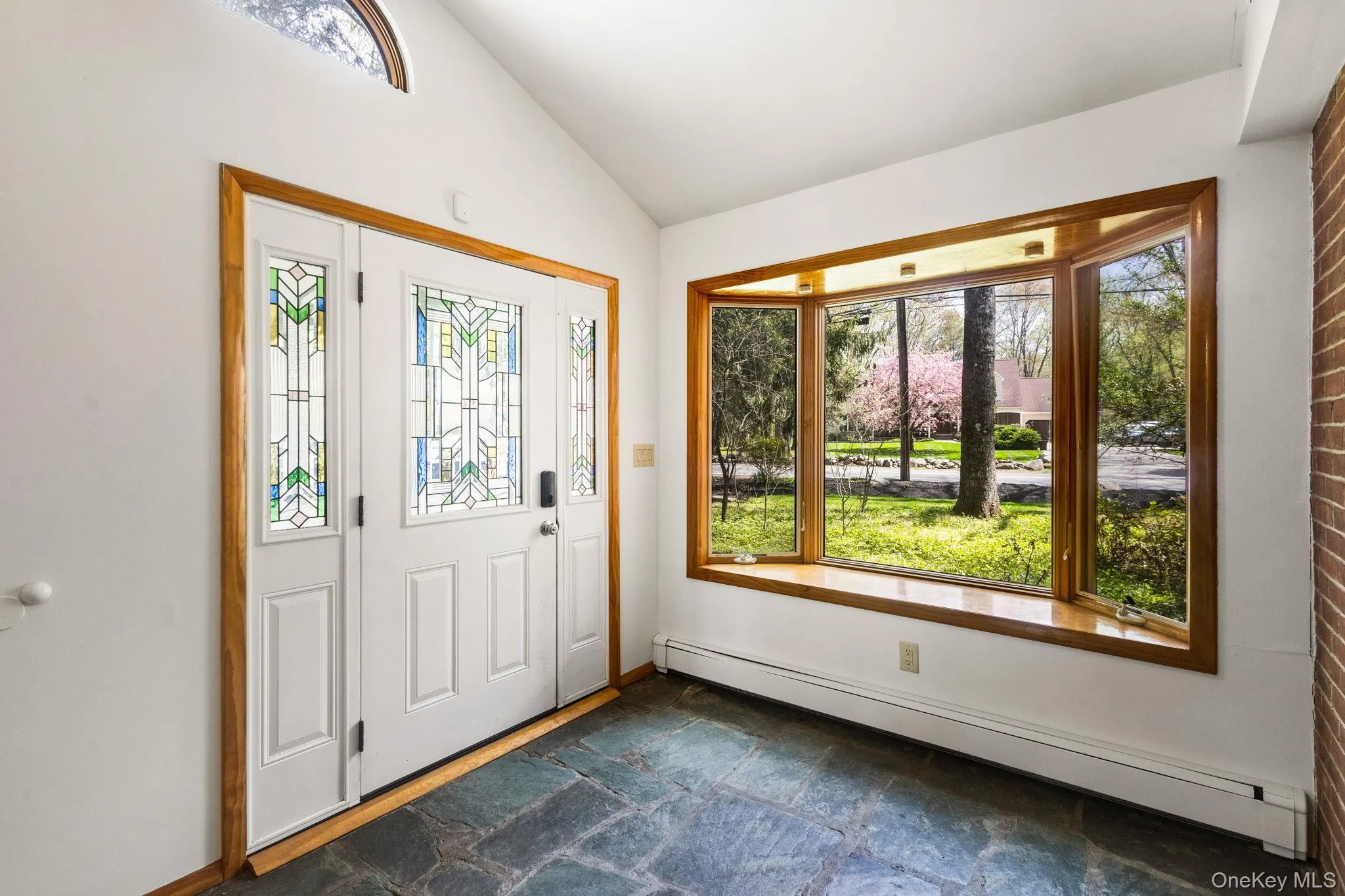 Peaked Ceiling for Height & Stained Glass Front Door w/Privacy Sidelights. Peaked Ceiling for Height & Stained Glass Front Door w/Privacy Sidelights.