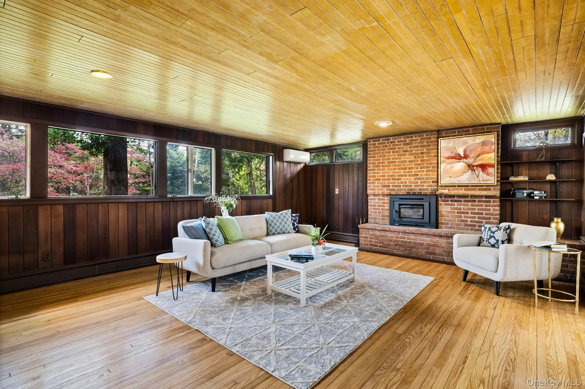 Bank of Windows brings Nature and Light into the Quiet Living Room Area. Bank of Windows brings Nature and Light into the Quiet Living Room Area.