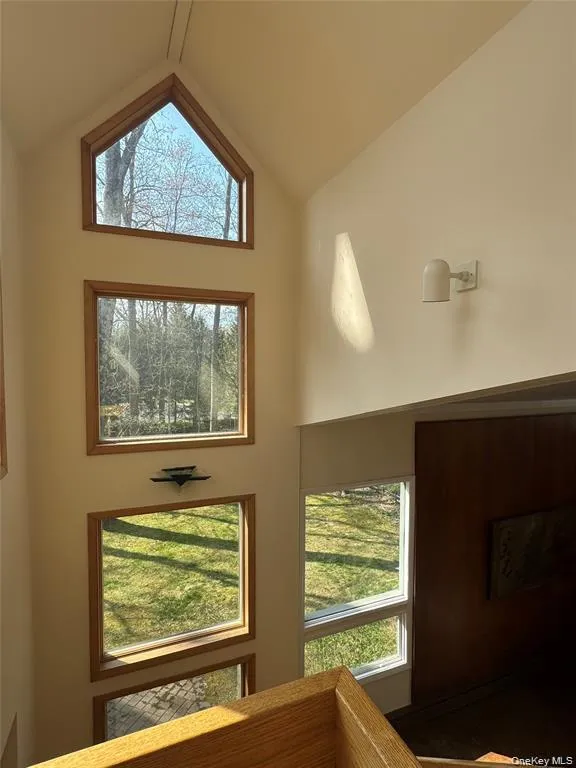Architectural WindowsJuxtaposed at Center of two Level Oak Staircase. Architectural WindowsJuxtaposed at Center of two Level Oak Staircase.