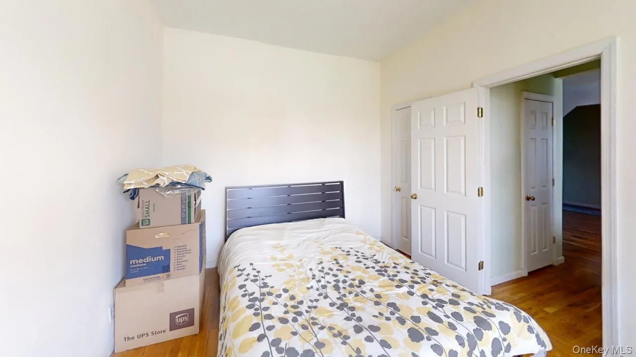 Bedroom with wood finished floors and baseboards Bedroom with wood finished floors and baseboards