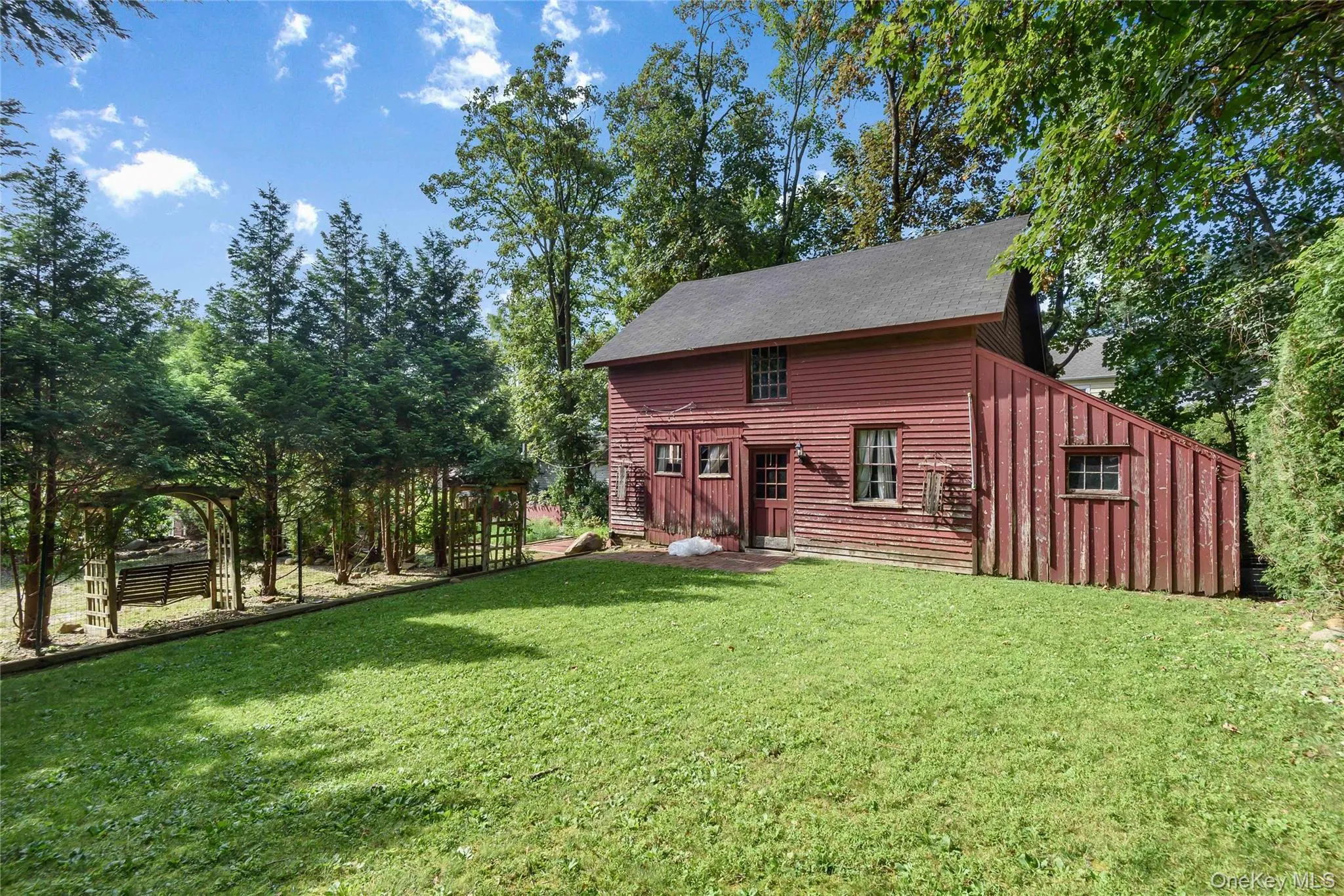 Back of house, Barn, featuring a yard and trees Back of house, Barn, featuring a yard and trees