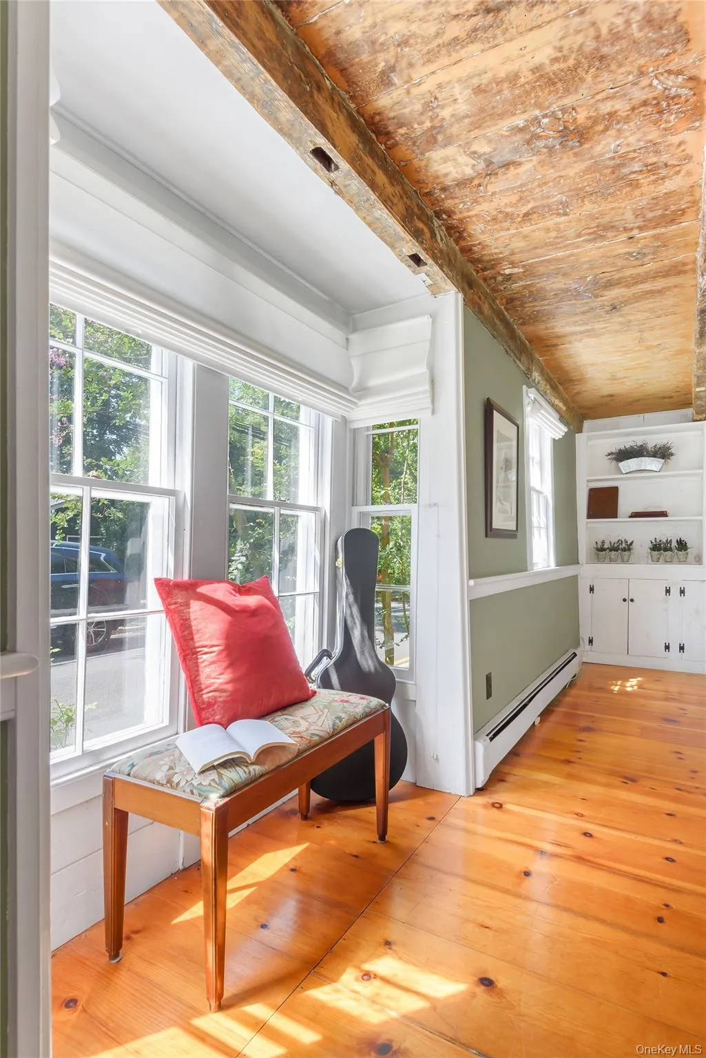 Sitting room featuring a baseboard heating unit, light wood-style floors, and wooden ceiling Sitting room featuring a baseboard heating unit, light wood-style floors, and wooden ceiling