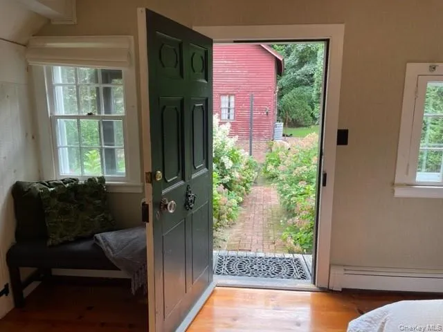 Doorway to outside featuring wood finished floors Doorway to outside featuring wood finished floors