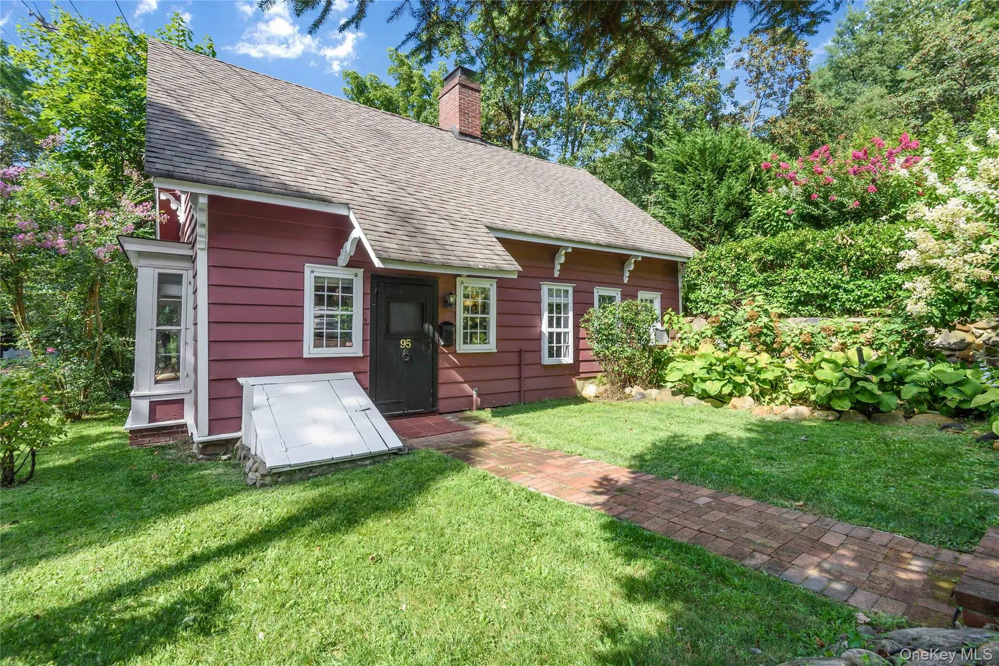 Back of house featuring a chimney, roof with shingles, and a yard Back of house featuring a chimney, roof with shingles, and a yard