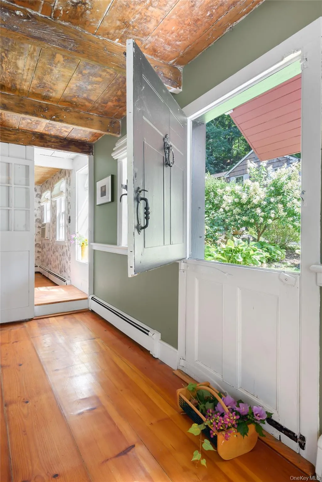 Doorway to outside featuring a baseboard heating unit, hardwood / wood-style flooring, and wooden ceiling Doorway to outside featuring a baseboard heating unit, hardwood / wood-style flooring, and wooden ceiling