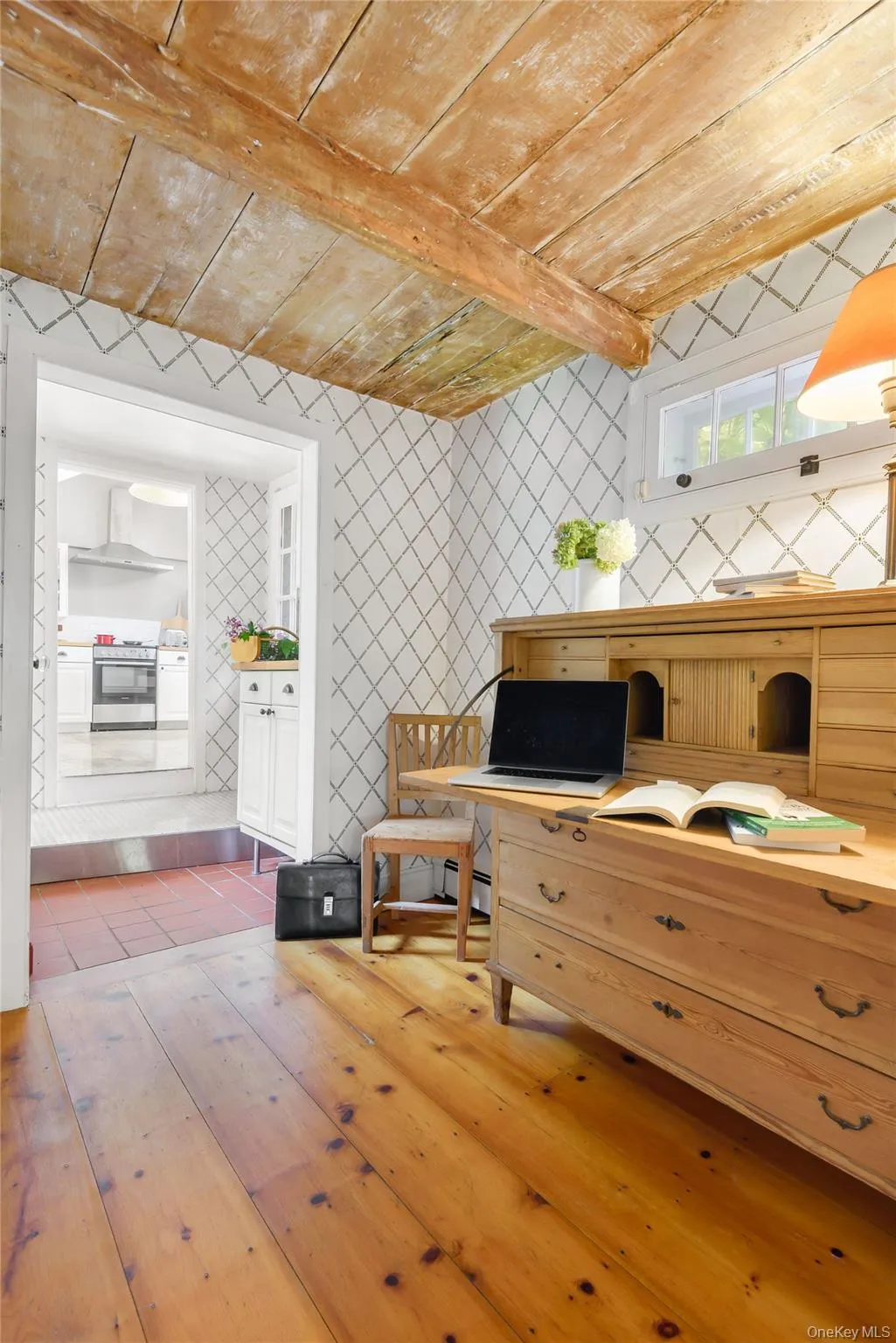 Office area with light wood finished floors, a wood ceiling with exposed beams Office area with light wood finished floors, a wood ceiling with exposed beams