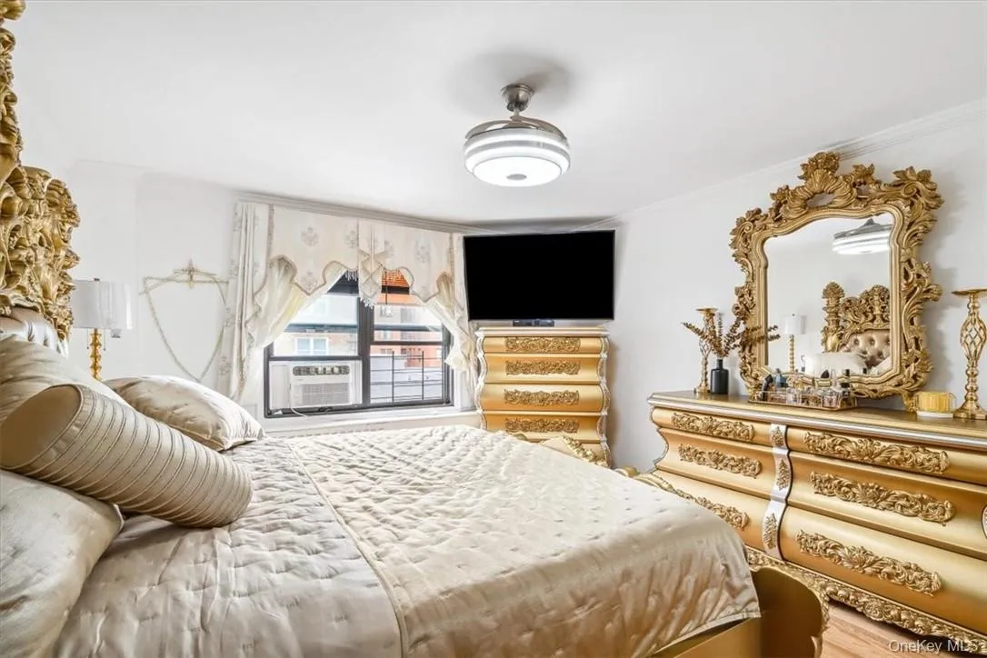 Bedroom featuring crown molding and hardwood / wood-style floors Bedroom featuring crown molding and hardwood / wood-style floors