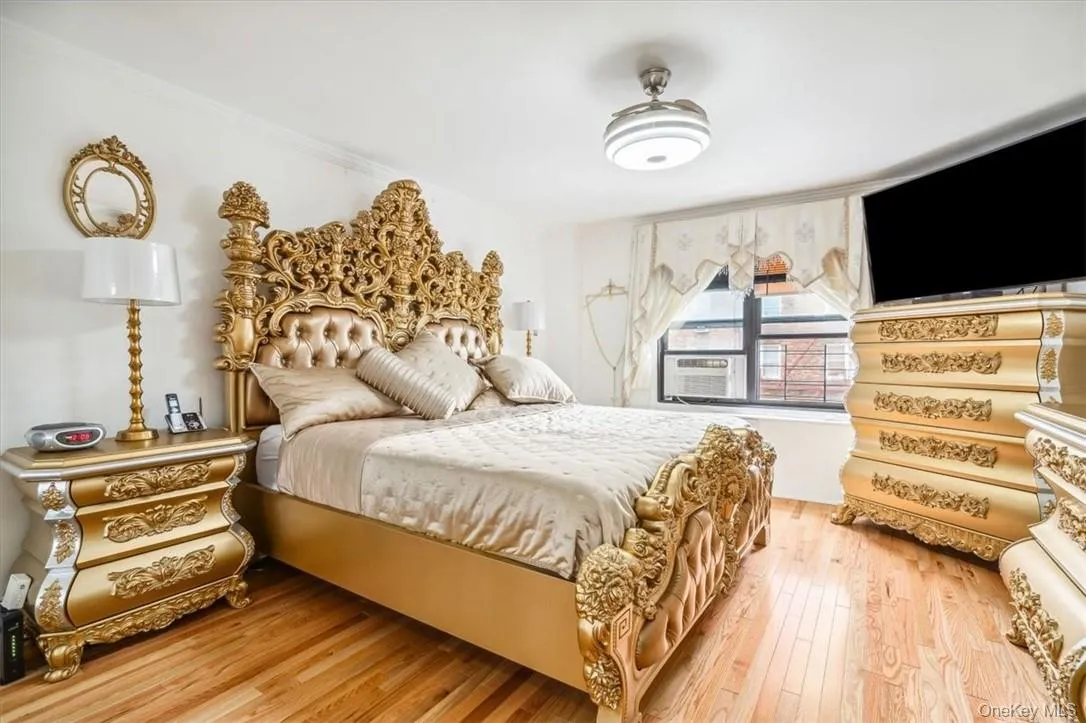 Bedroom featuring ornamental molding and hardwood / wood-style floors Bedroom featuring ornamental molding and hardwood / wood-style floors