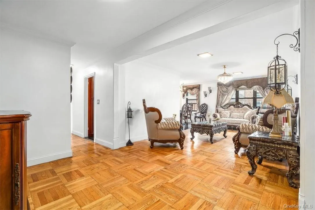 Living area with light parquet floors and ornamental molding Living area with light parquet floors and ornamental molding