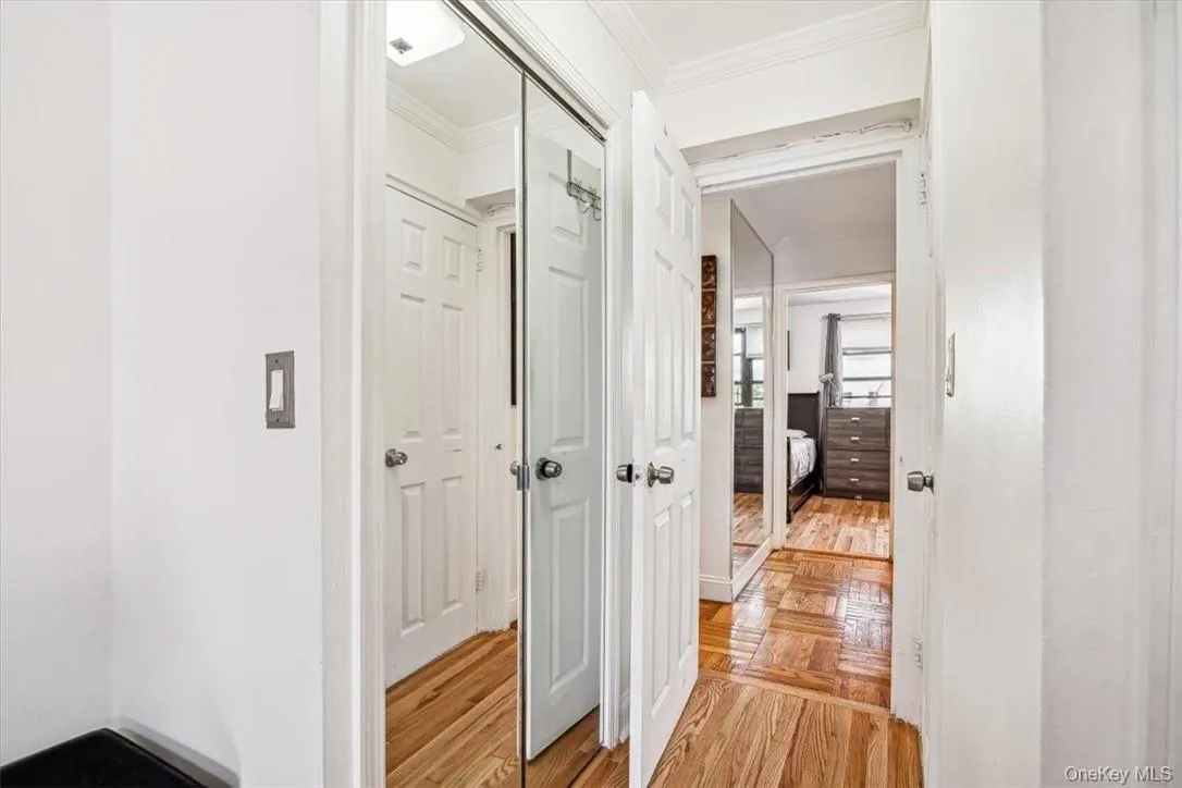 Hallway with light parquet floors and crown molding Hallway with light parquet floors and crown molding