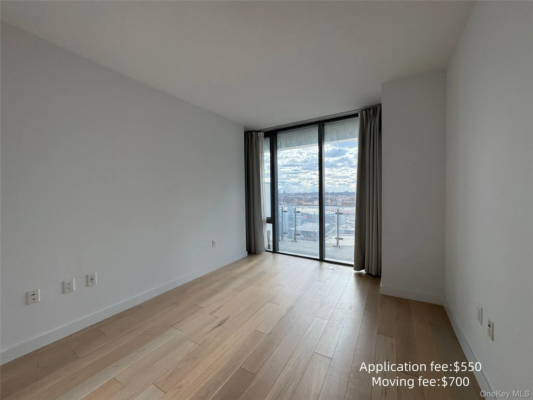 Empty room with expansive windows and light wood finished floors Empty room with expansive windows and light wood finished floors