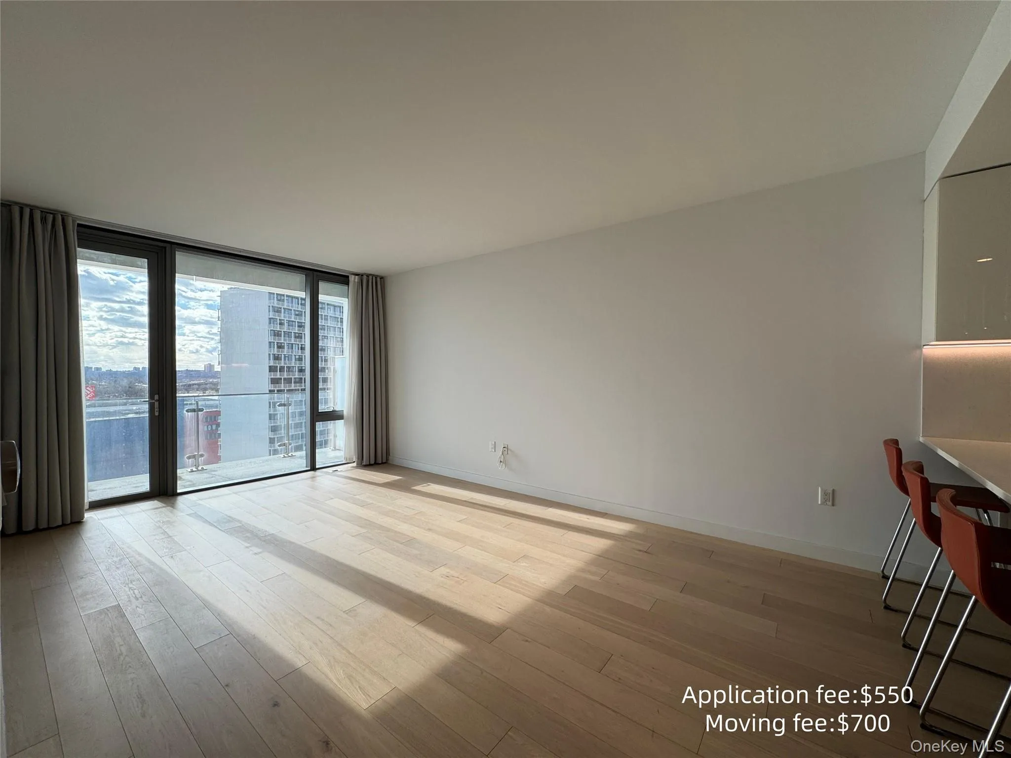 Unfurnished room featuring floor to ceiling windows and light wood-type flooring Unfurnished room featuring floor to ceiling windows and light wood-type flooring