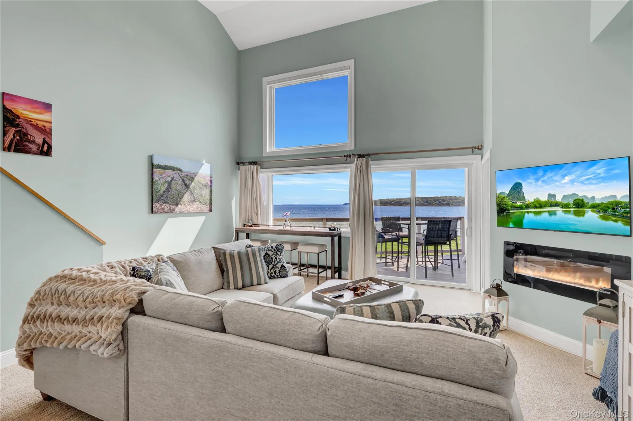 Living room has amazing views over the water and double height ceilings makes the space feel open compared to other floor plans in the community. Living room has amazing views over the water and double height ceilings makes the space feel open compared to other floor plans in the community.
