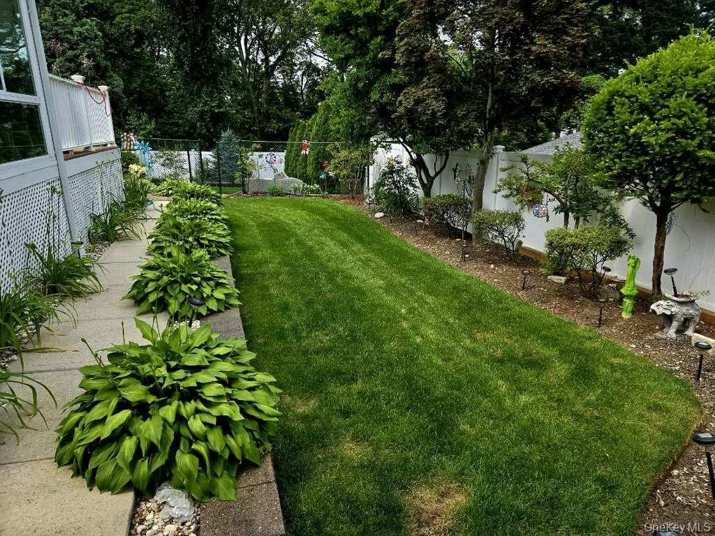 Backyard with retaining wall, igs, and specimen plantings Backyard with retaining wall, igs, and specimen plantings