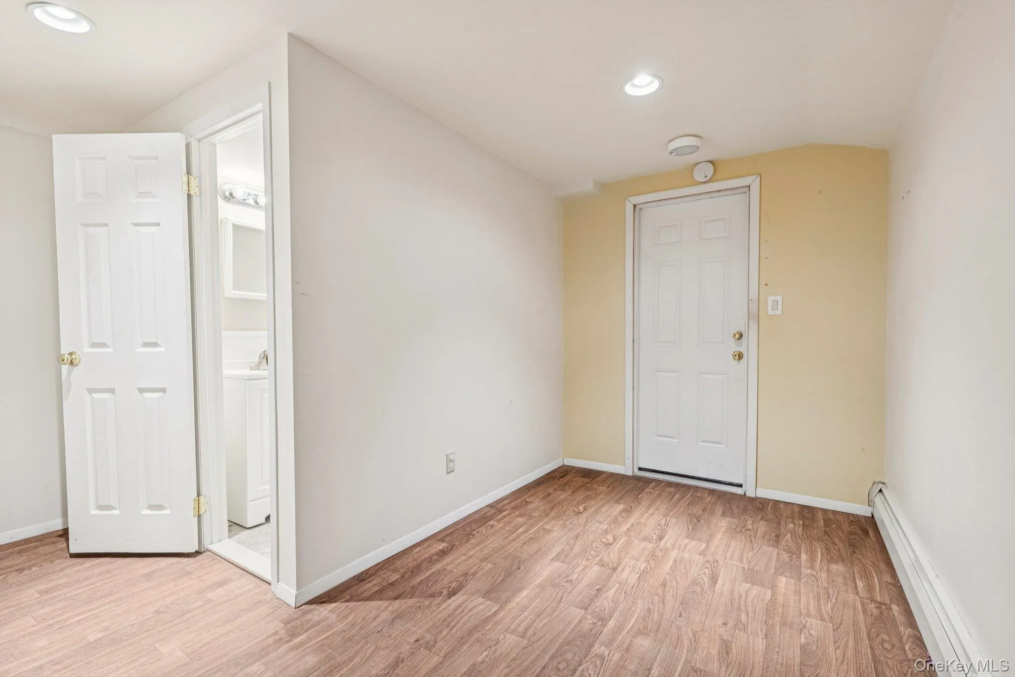 Lower level room with entrance to one of the 2 garages Lower level room with entrance to one of the 2 garages