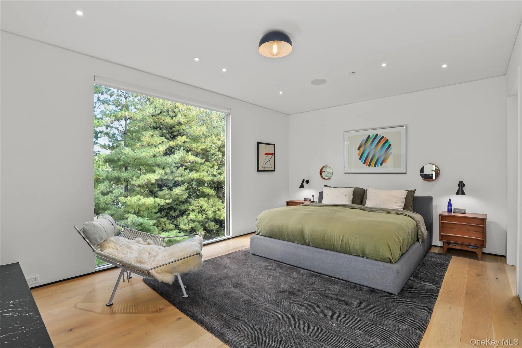 Primary Bedroom – Spacious retreat with fireplace and peaceful outlook. Primary Bedroom – Spacious retreat with fireplace and peaceful outlook.