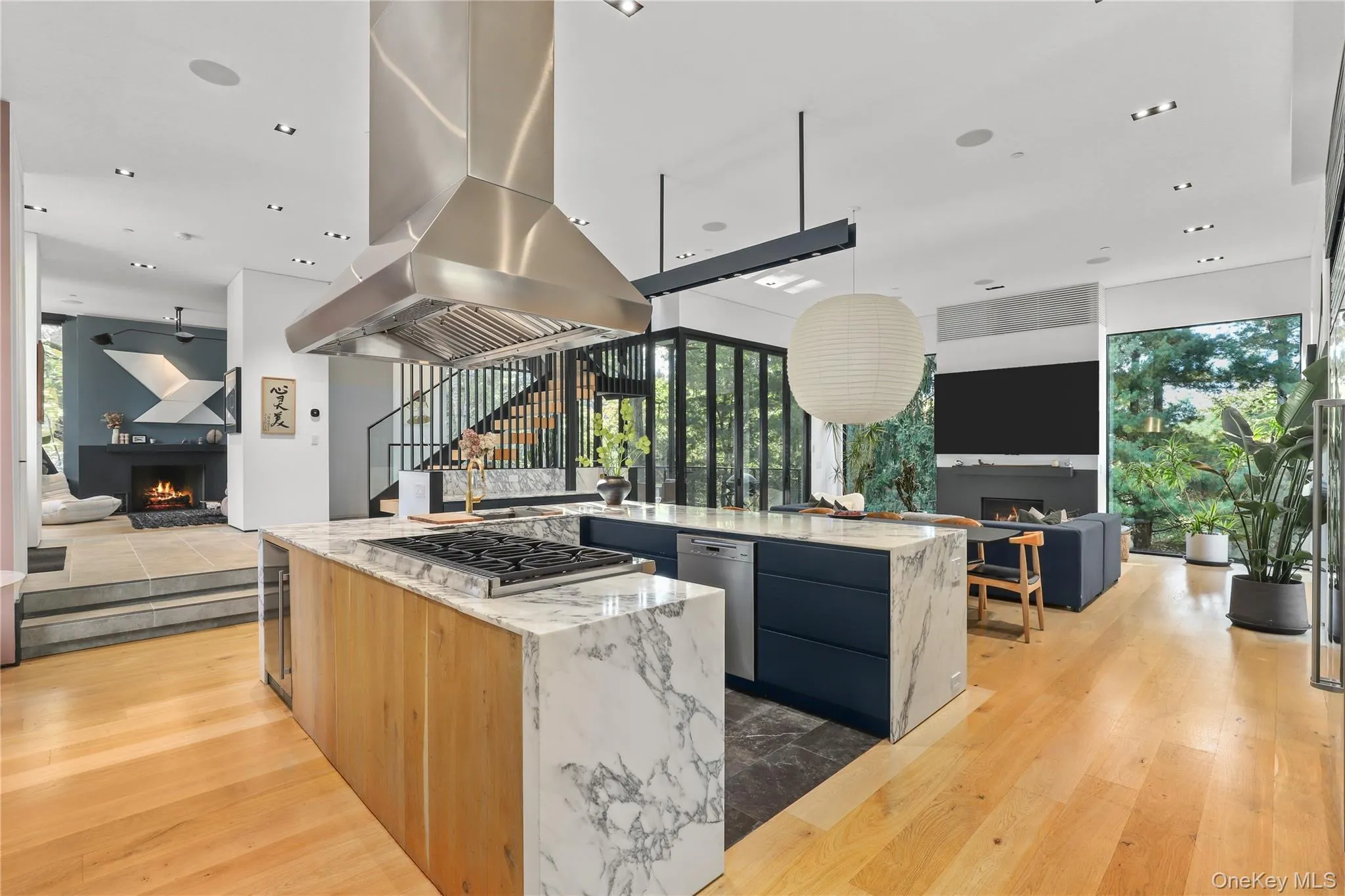 Kitchen – Custom cabinetry and Arabescato stone counters with a statement island. Kitchen – Custom cabinetry and Arabescato stone counters with a statement island.