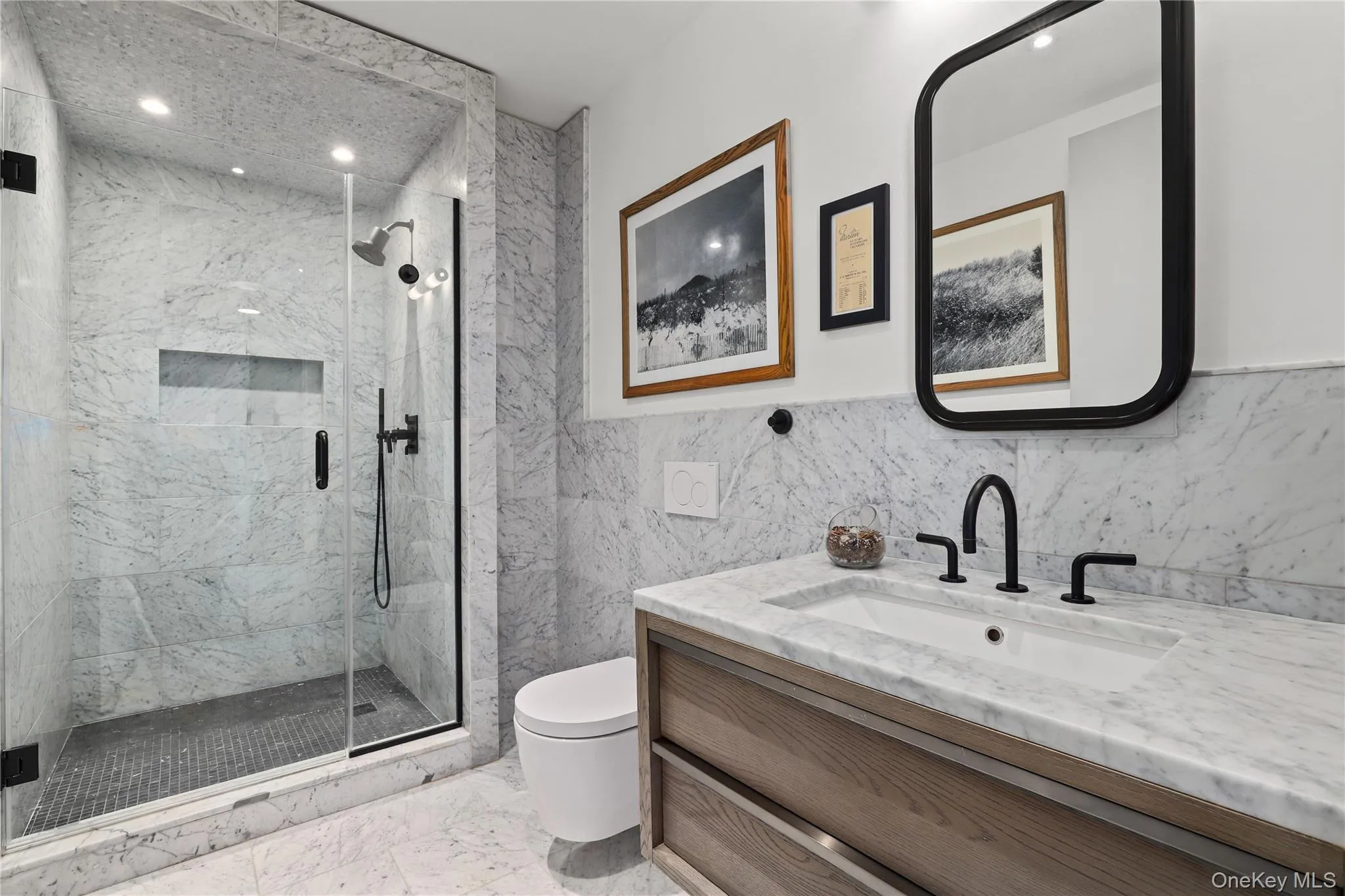 En-Suite Bath – Marble and herringbone tile with premium, wall-hung fixtures. En-Suite Bath – Marble and herringbone tile with premium, wall-hung fixtures.