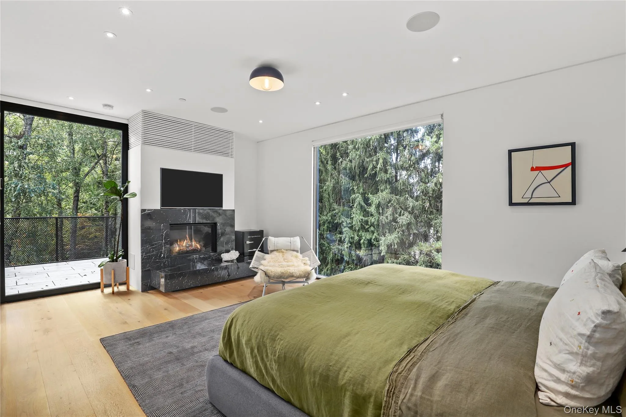 Primary Suite View – Walls of glass bring in natural light and greenery. Primary Suite View – Walls of glass bring in natural light and greenery.
