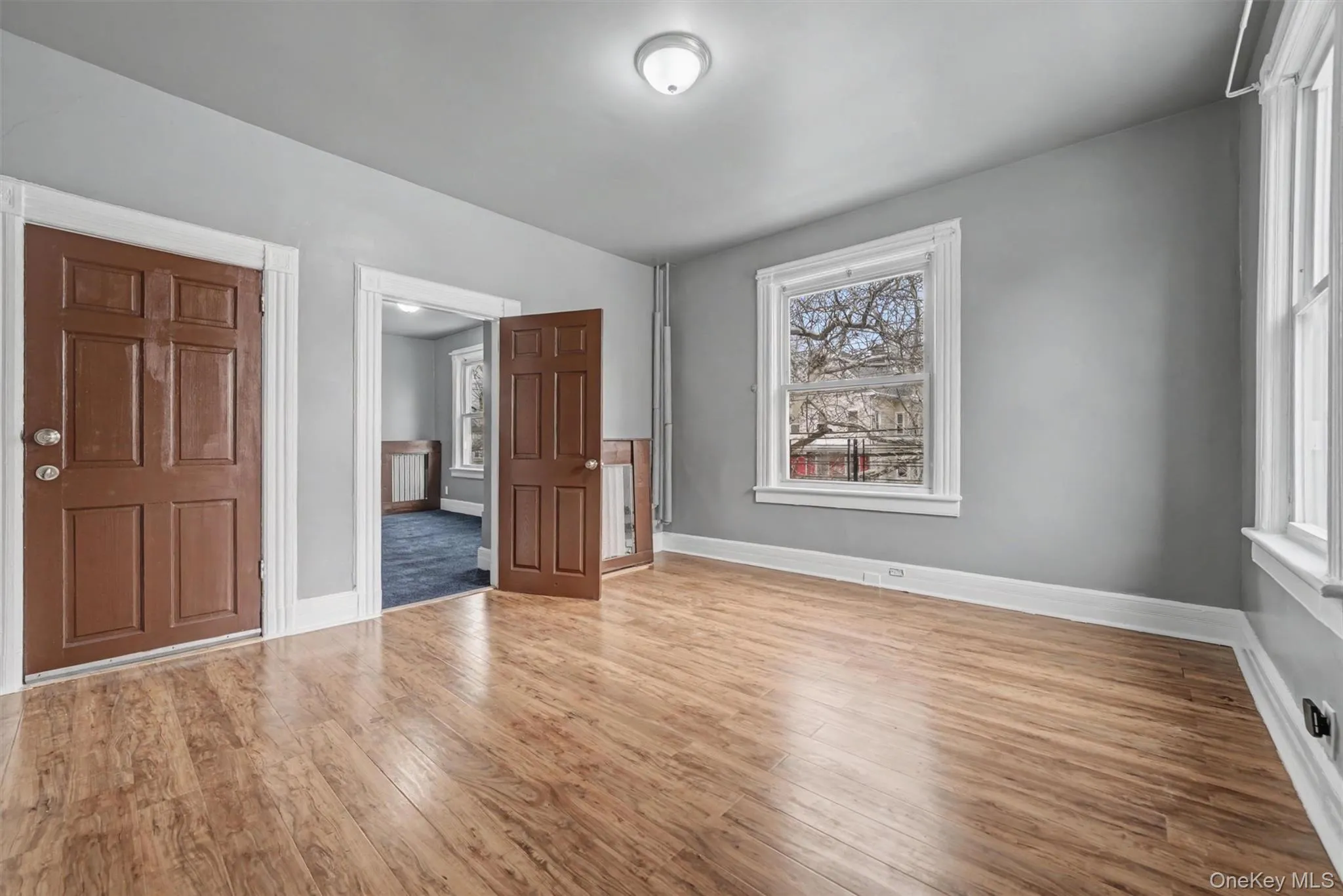 Living Room with view into Bedroom 2. Door to the left is the entrance to the apartment. Living Room with view into Bedroom 2. Door to the left is the entrance to the apartment.