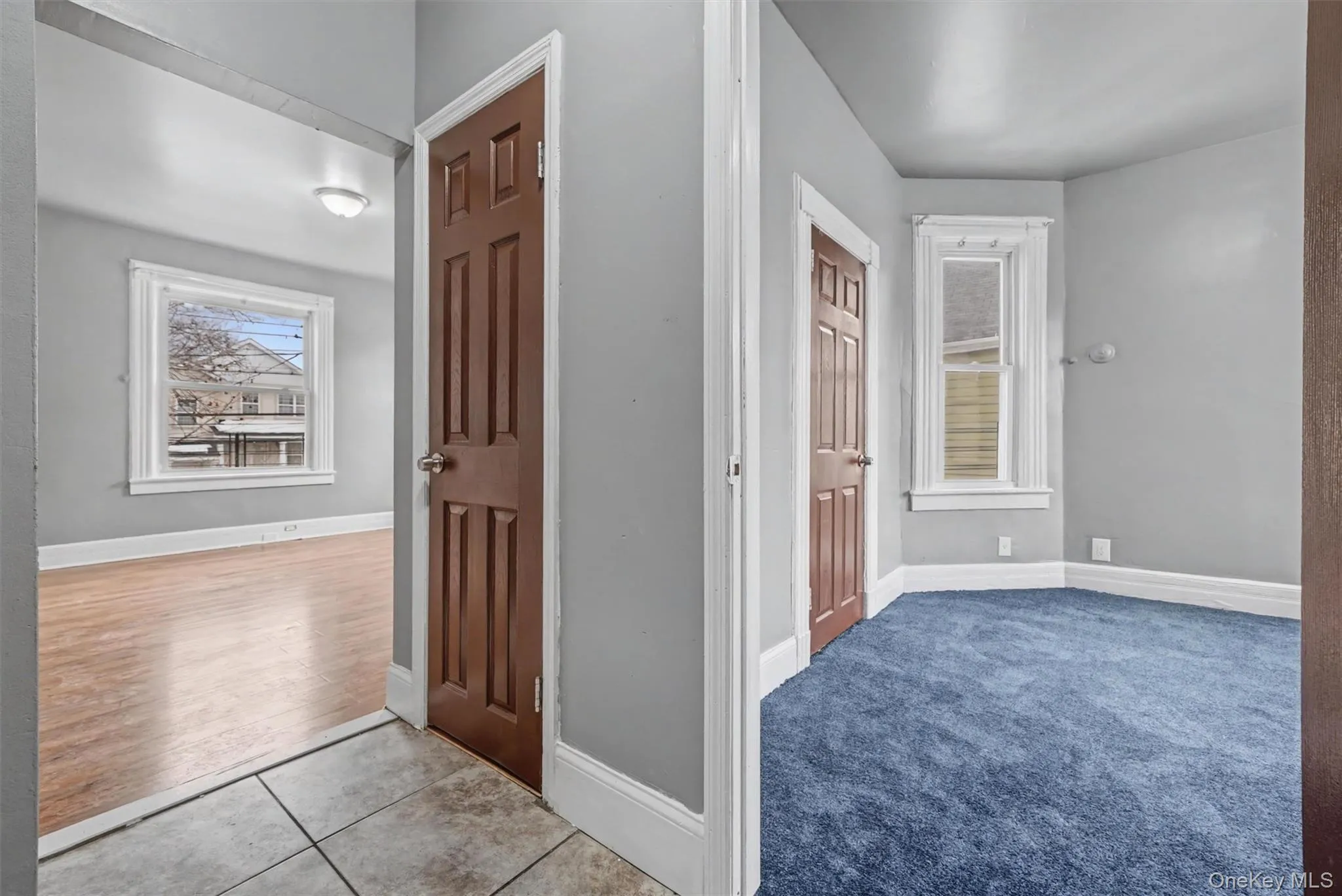 View from Center hall into living room and bedroom 1. Also shown is hall closet. View from Center hall into living room and bedroom 1. Also shown is hall closet.