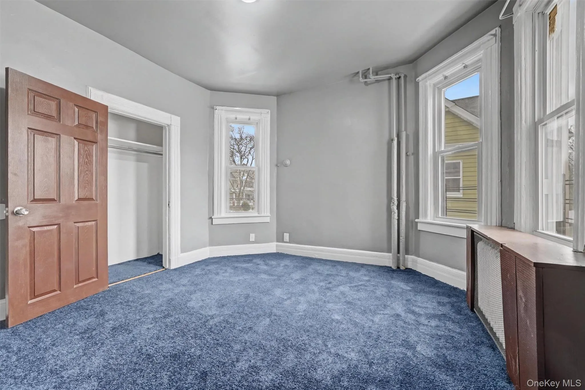 Large Primary bedroom 1 with lots of light and space. Brand new wall-to-wall carpeting. Closet door is shown on the left. Large Primary bedroom 1 with lots of light and space. Brand new wall-to-wall carpeting. Closet door is shown on the left.