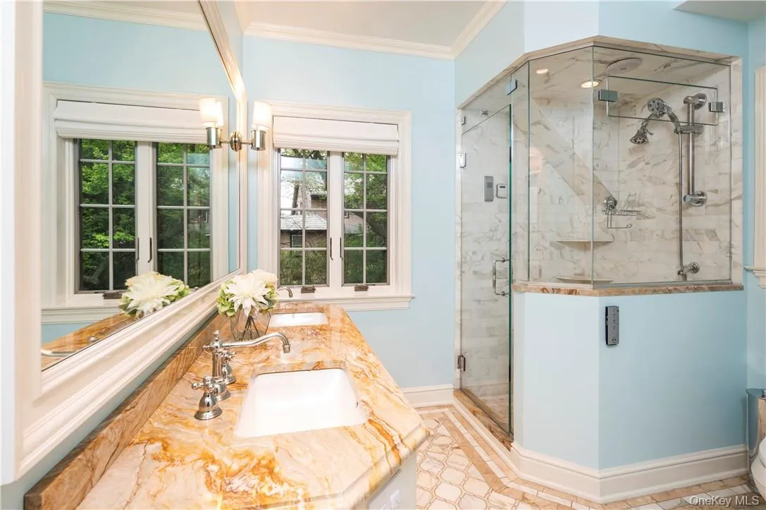 Primary En-Suite Marble Bath with Custom Tile Design, Vanity, Cabinetry and Radiant Heated floors Primary En-Suite Marble Bath with Custom Tile Design, Vanity, Cabinetry and Radiant Heated floors